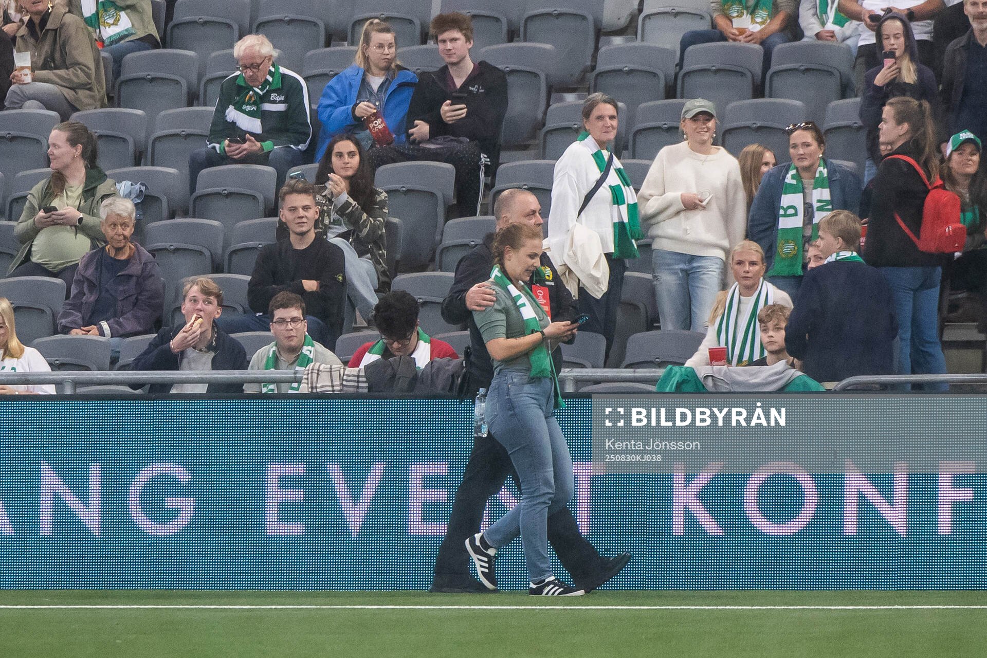 A security guard removes a spectator