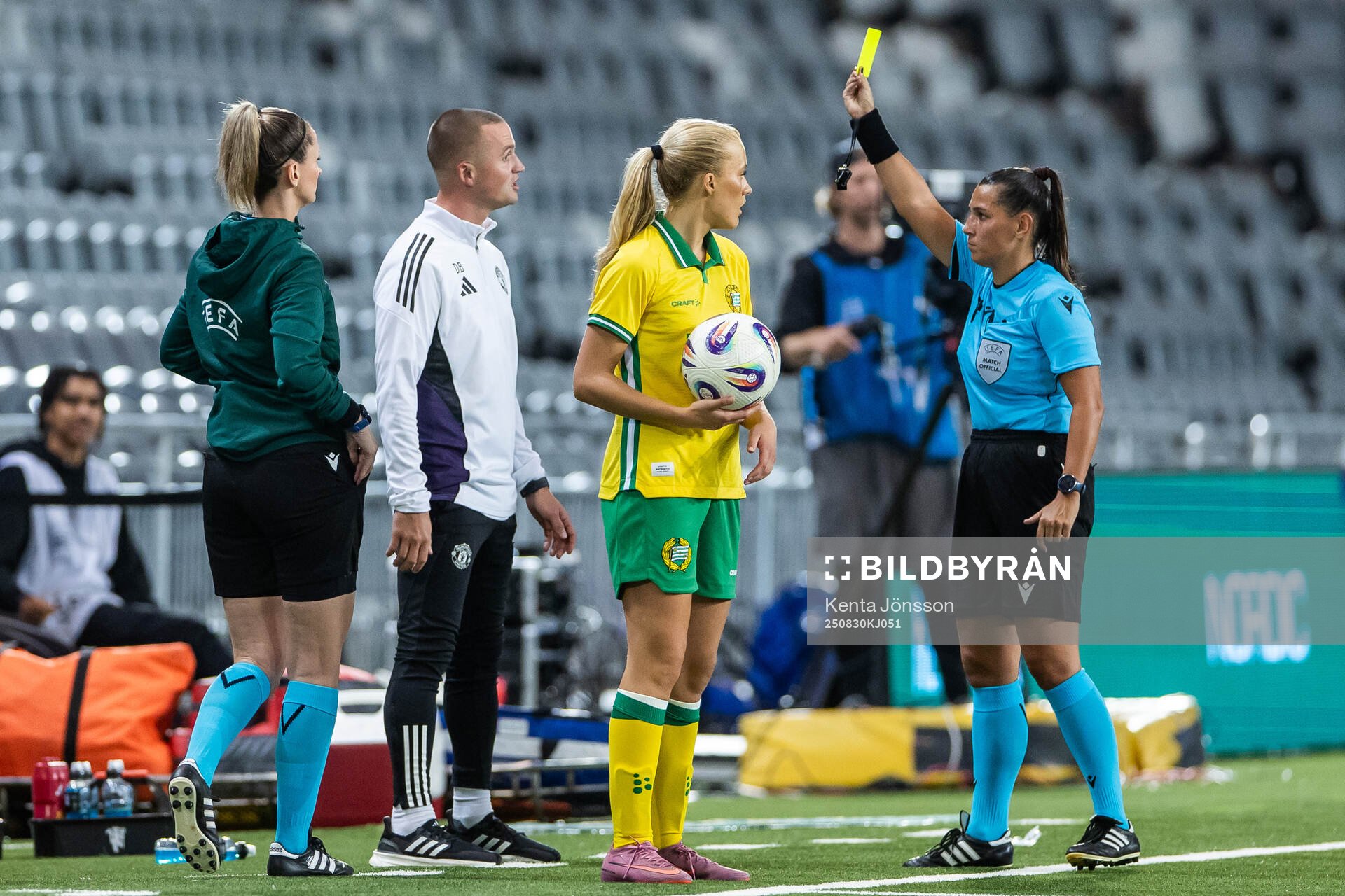 Referee Michaela Pachtova gives a yellow card to assistant