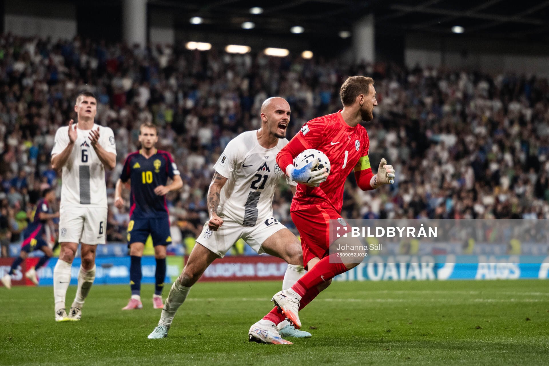 Vanja Drkusic and goalkeeper Jan Oblak of Slovenia celebrate