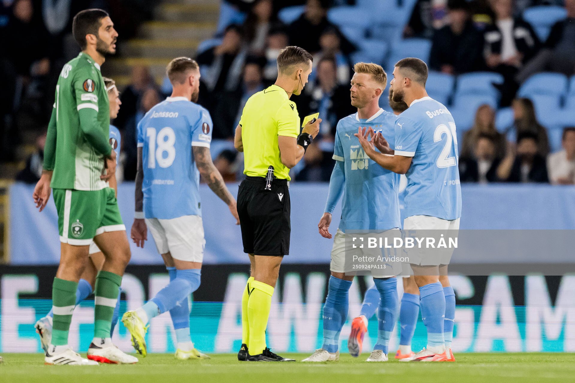 Referee Manfredas Lukjancukas  with Anders Christiansen and