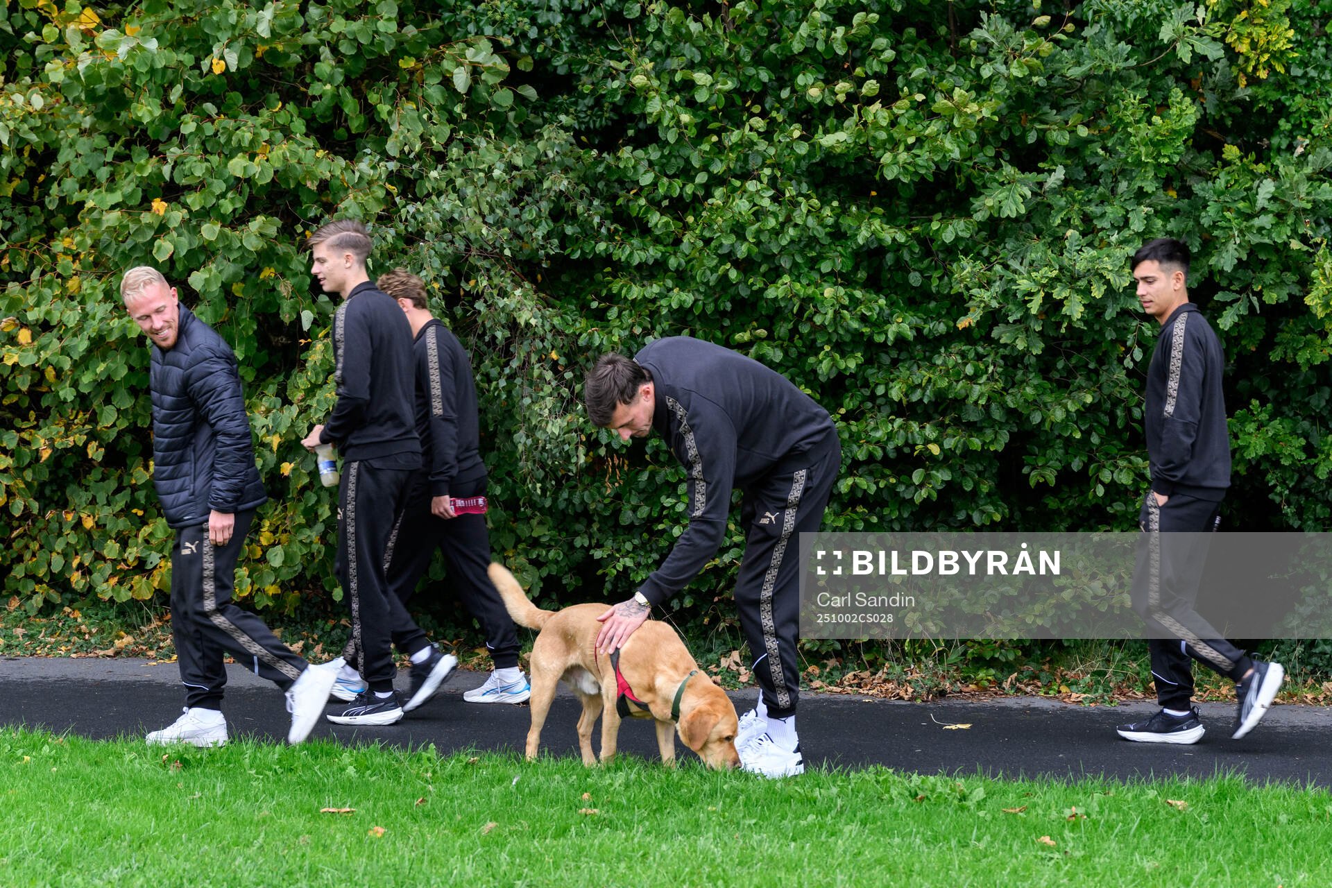 Goalkeeper Andreas Linde pets a dog