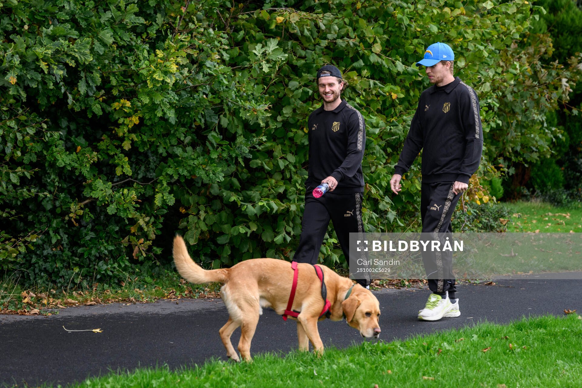 Adam Lundkvist and Simon Gustafson with a dog
