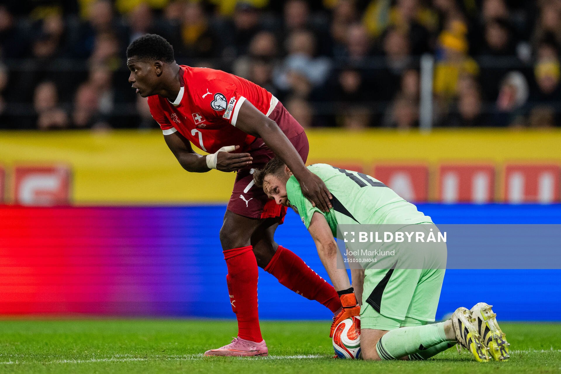 Breel Embolo of Switzerland and goalkeeper Viktor Johansson