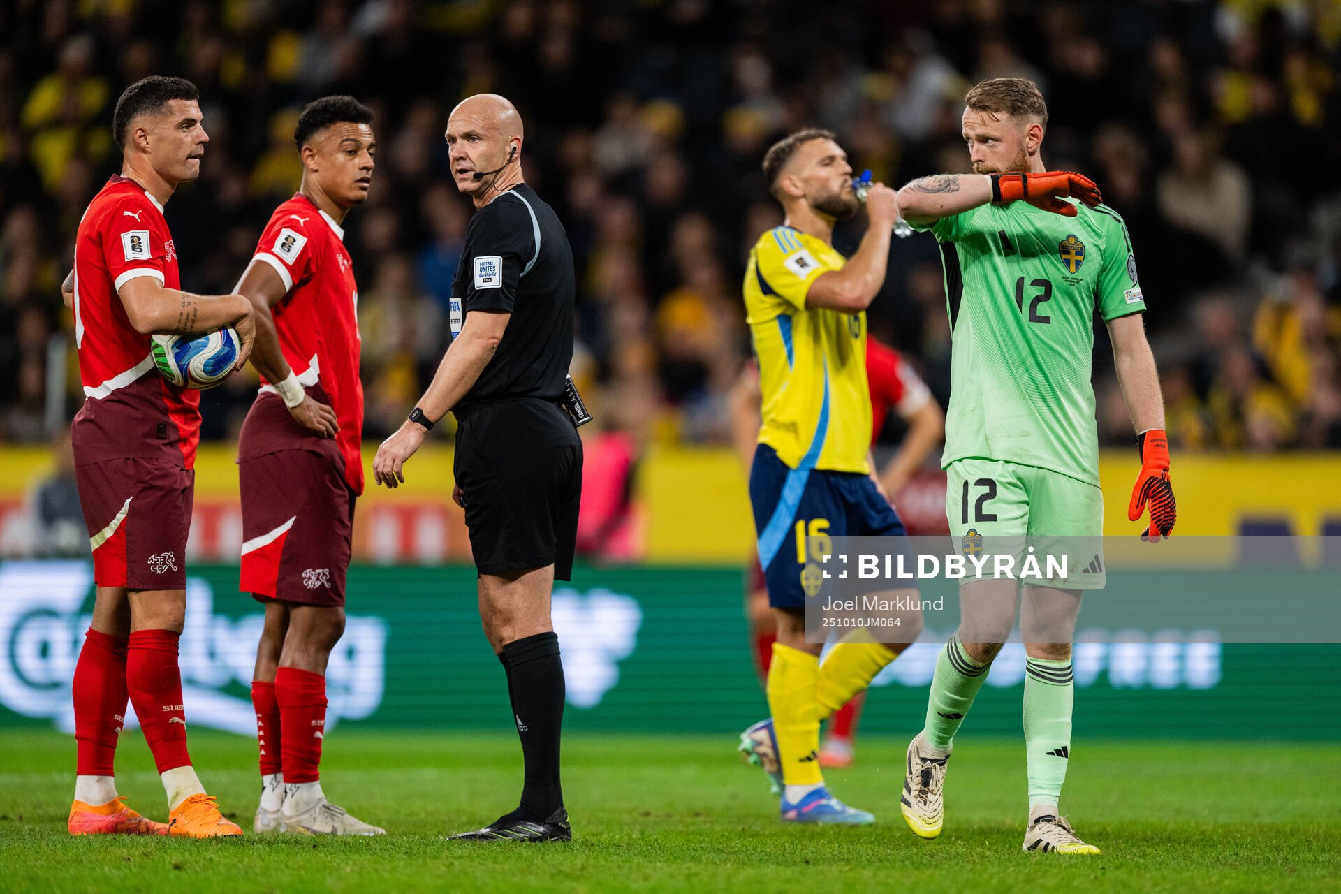 Granit Xhaka of Switzerland referee Anthony Taylor and