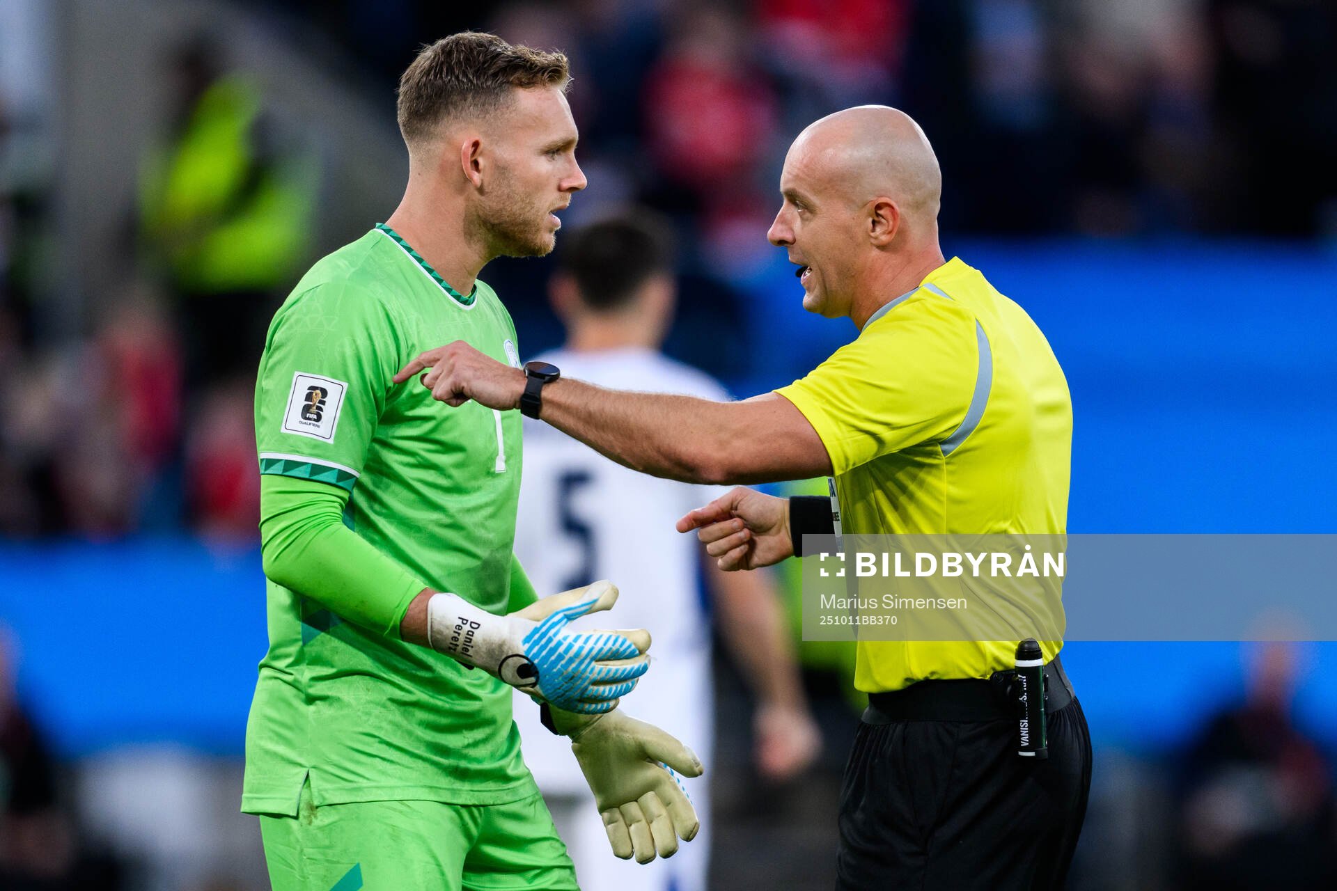goalkeeper Daniel Peretz of Israel and Referee Szymon
