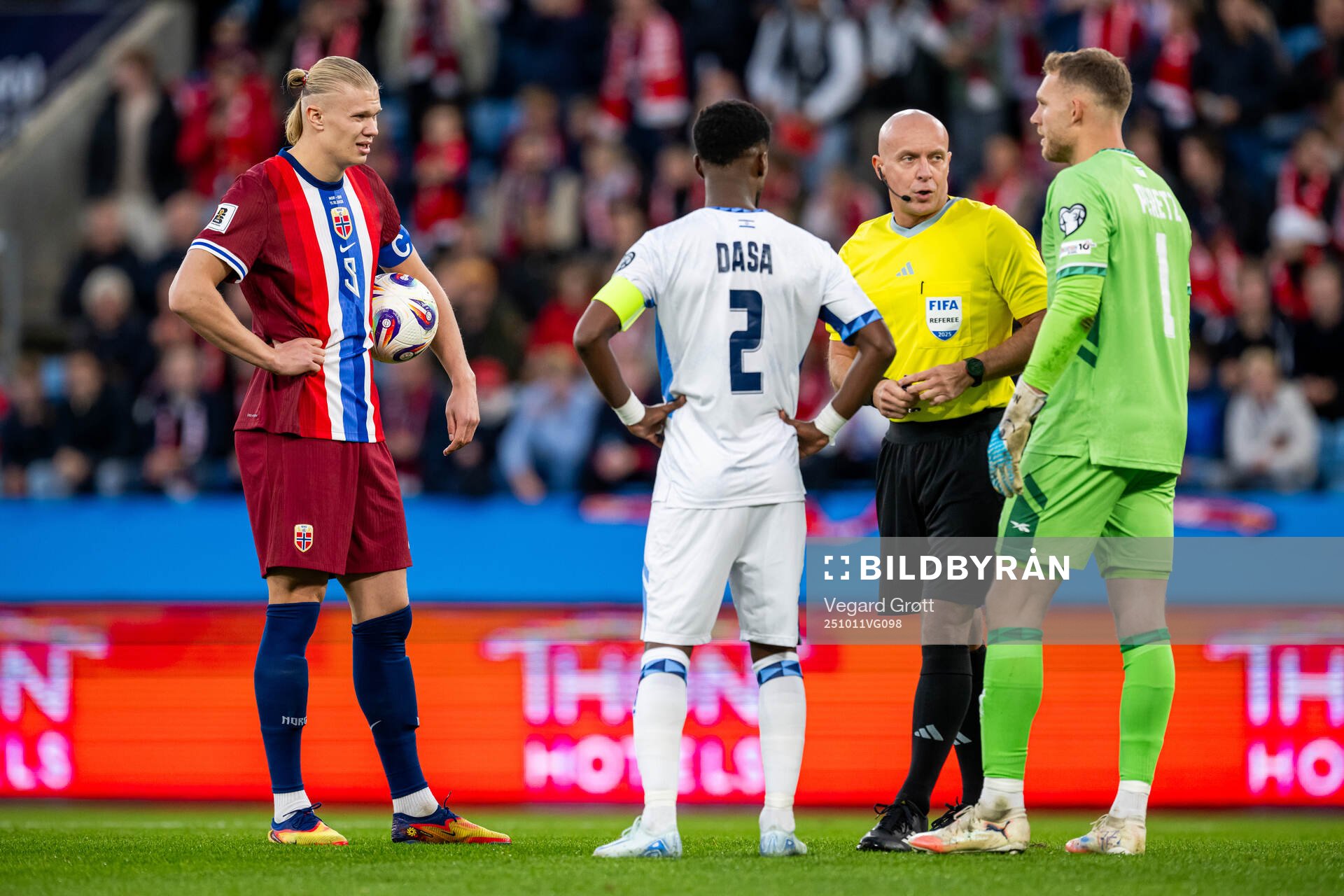 Erling Braut Haaland of Norway, Eli Dasa of Israel, referee