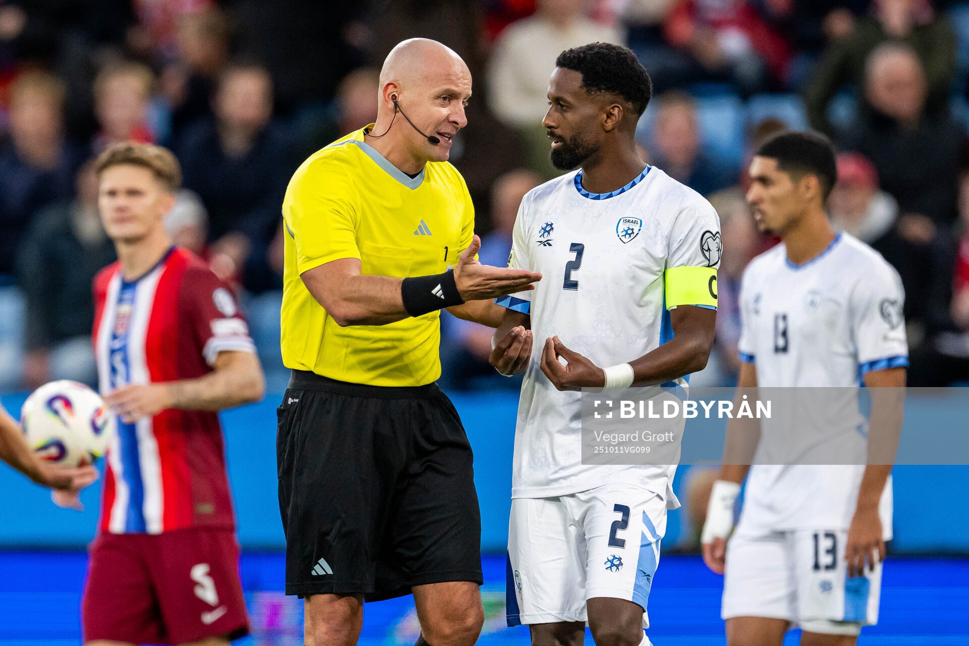 Referee Szymon Marciniak and Eli Dasa of Israel