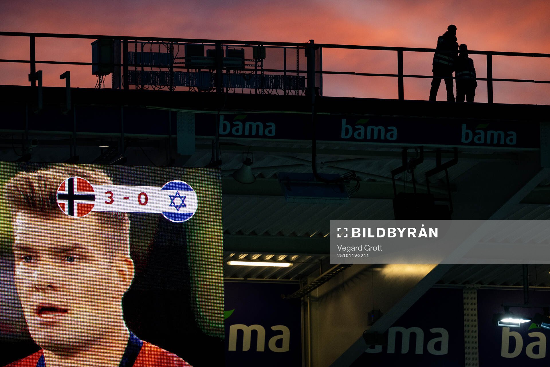 The silhouettes of two security guards standing at the