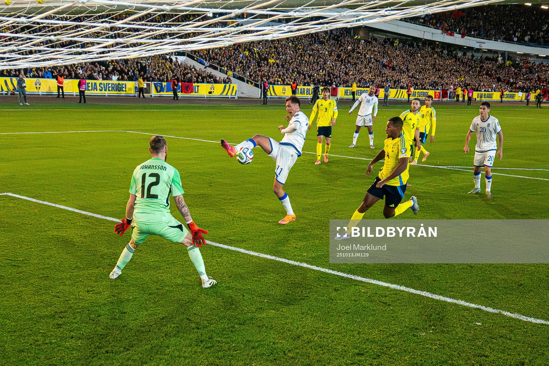 Fisnik Asllani of Kosovo scores 0-1 behind goalkeeper