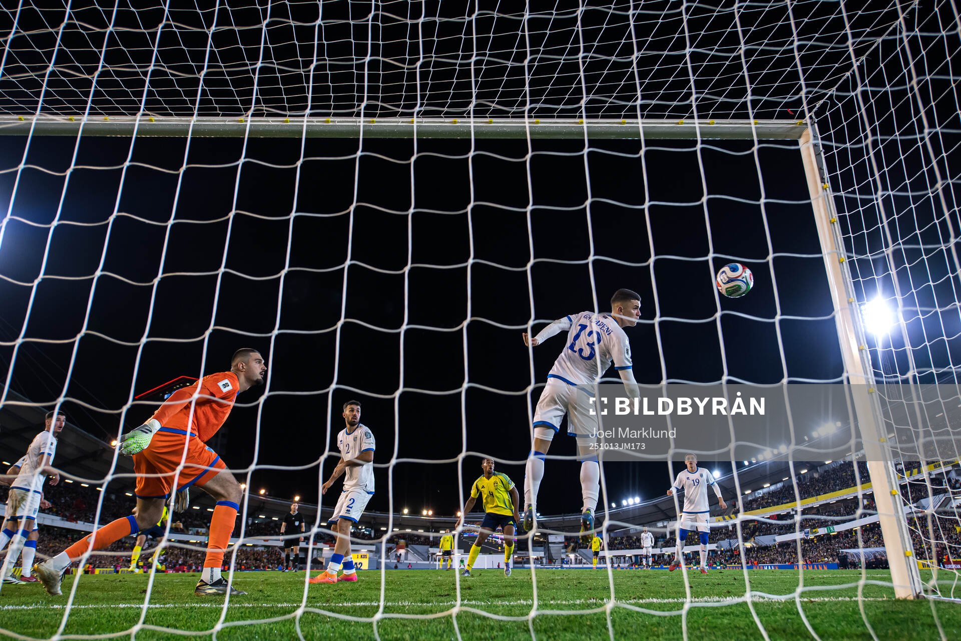 Goalkeeper Arijanet Muric sees Dion Gallapeni of Kosovo
