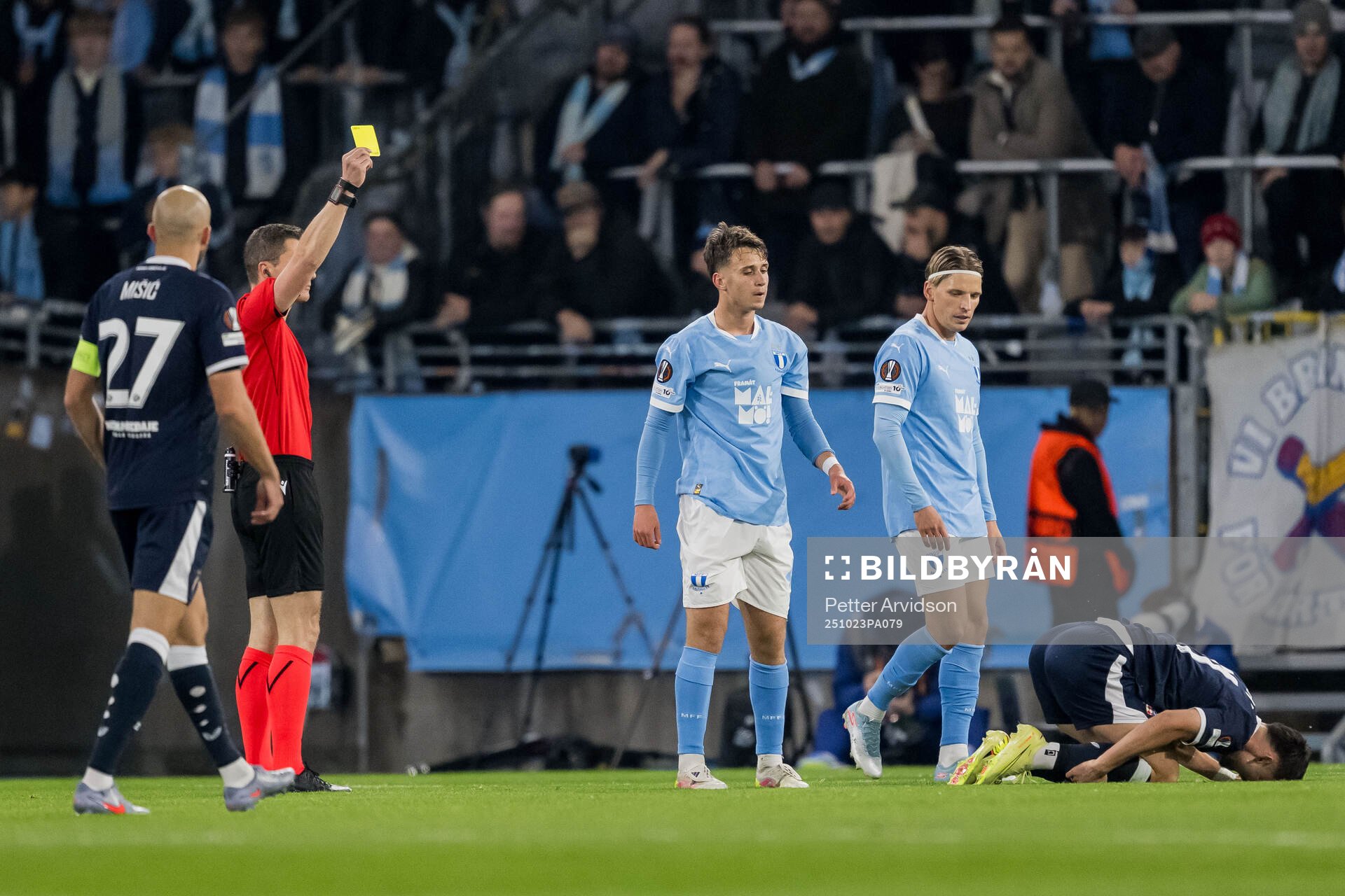 Kenan Busuladzic of Malmö FF receives a yellow card