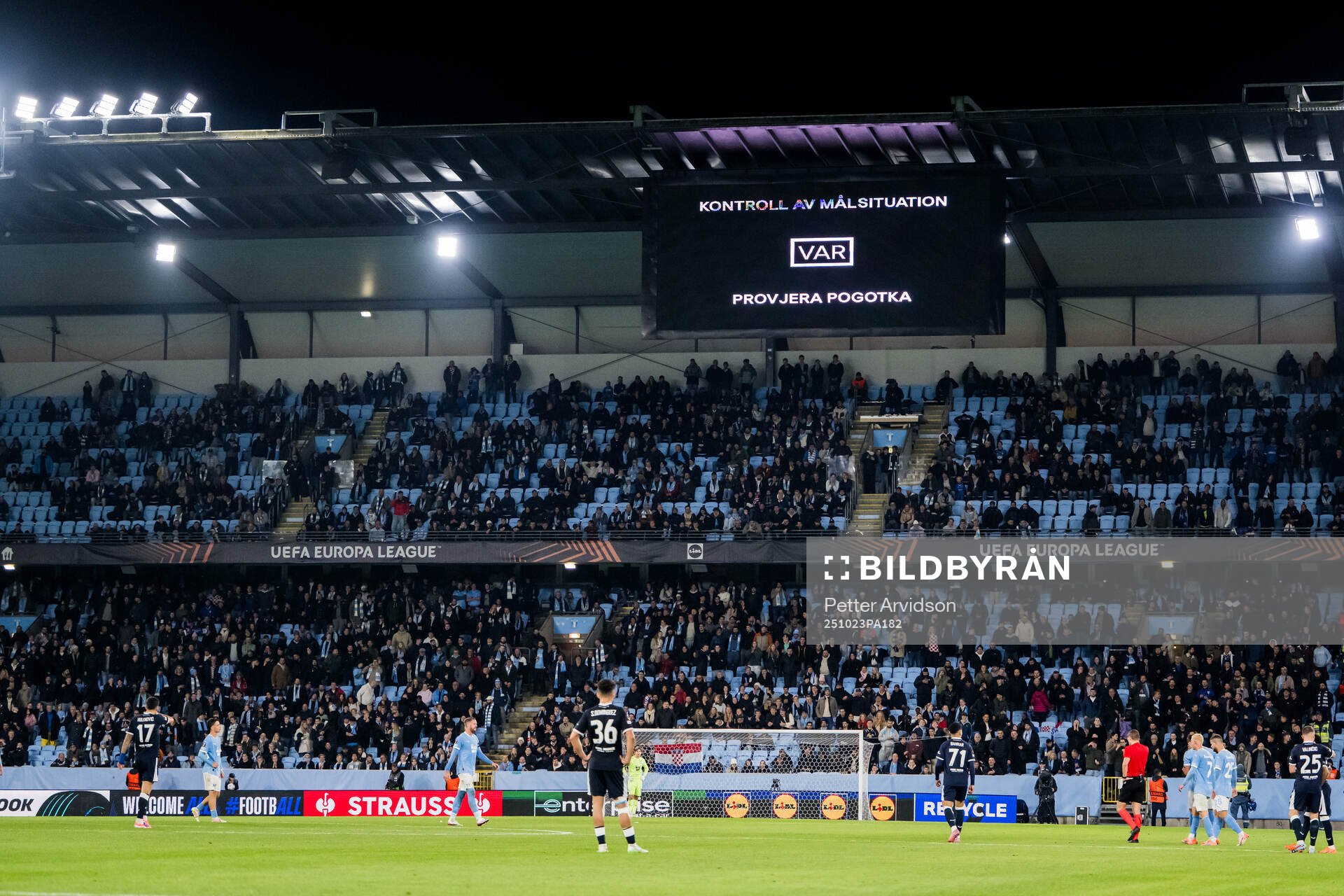 The big screen displays a VAR review message