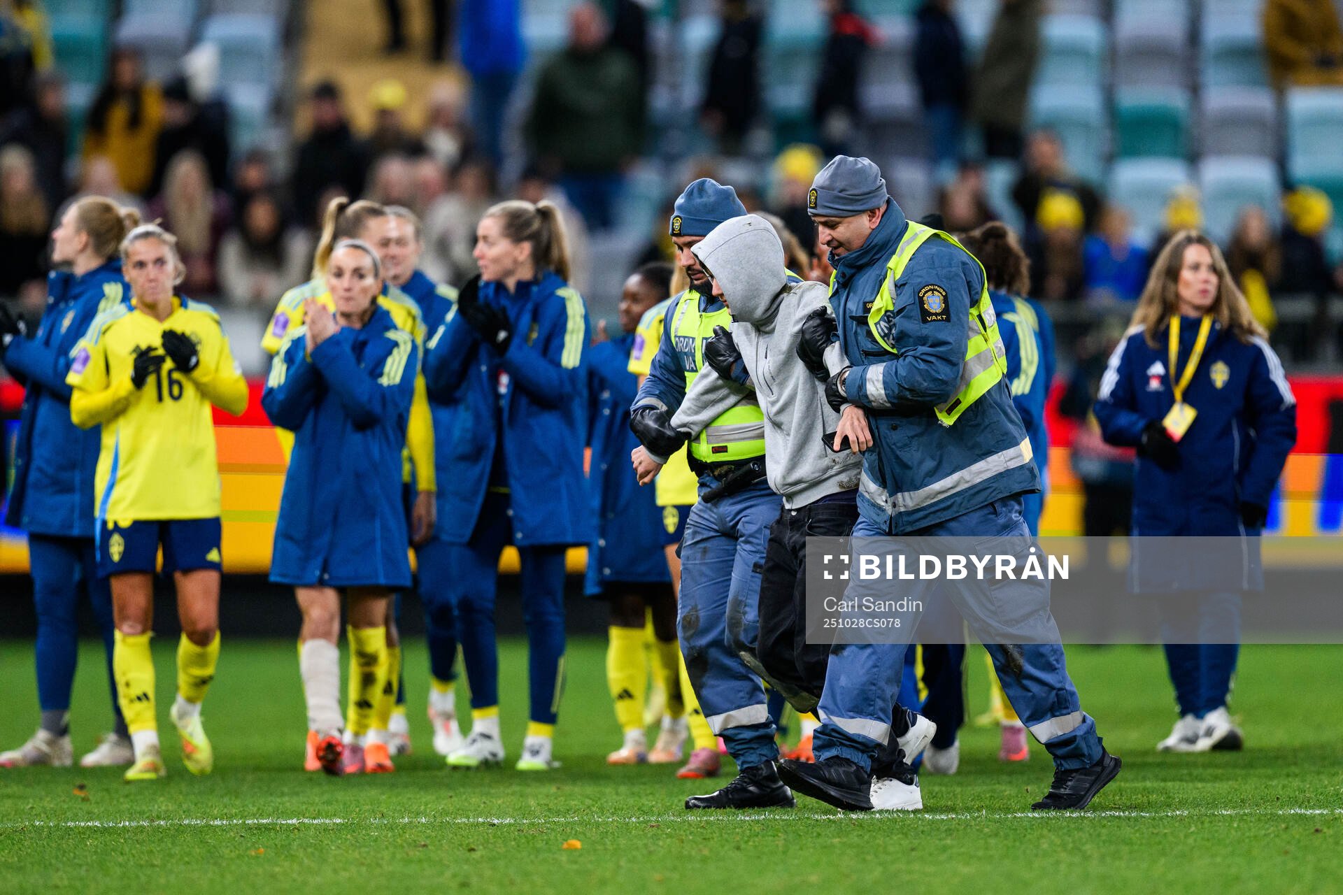 A pitch invader is taken by security