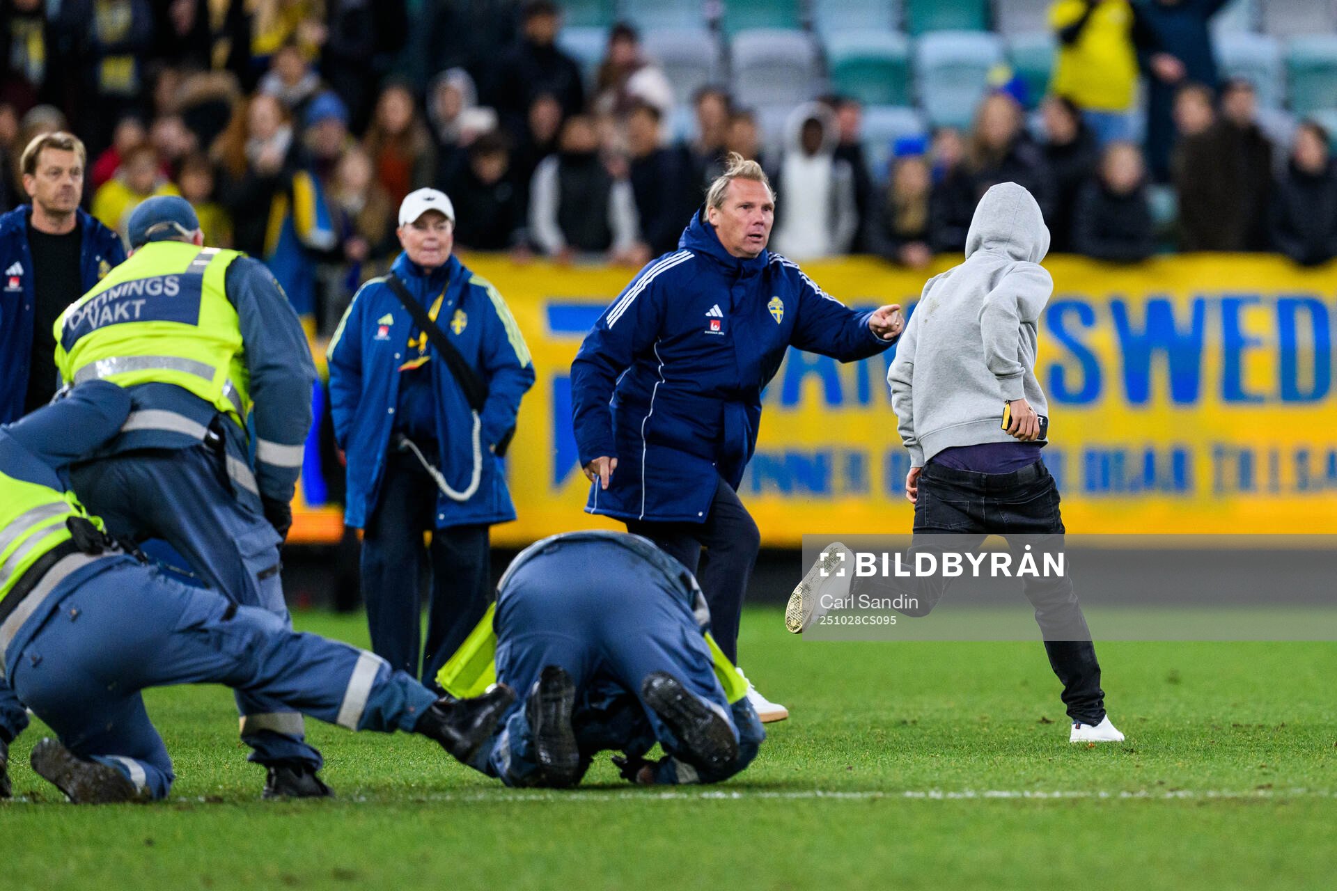 Security manager Lars From stops a pitch invader