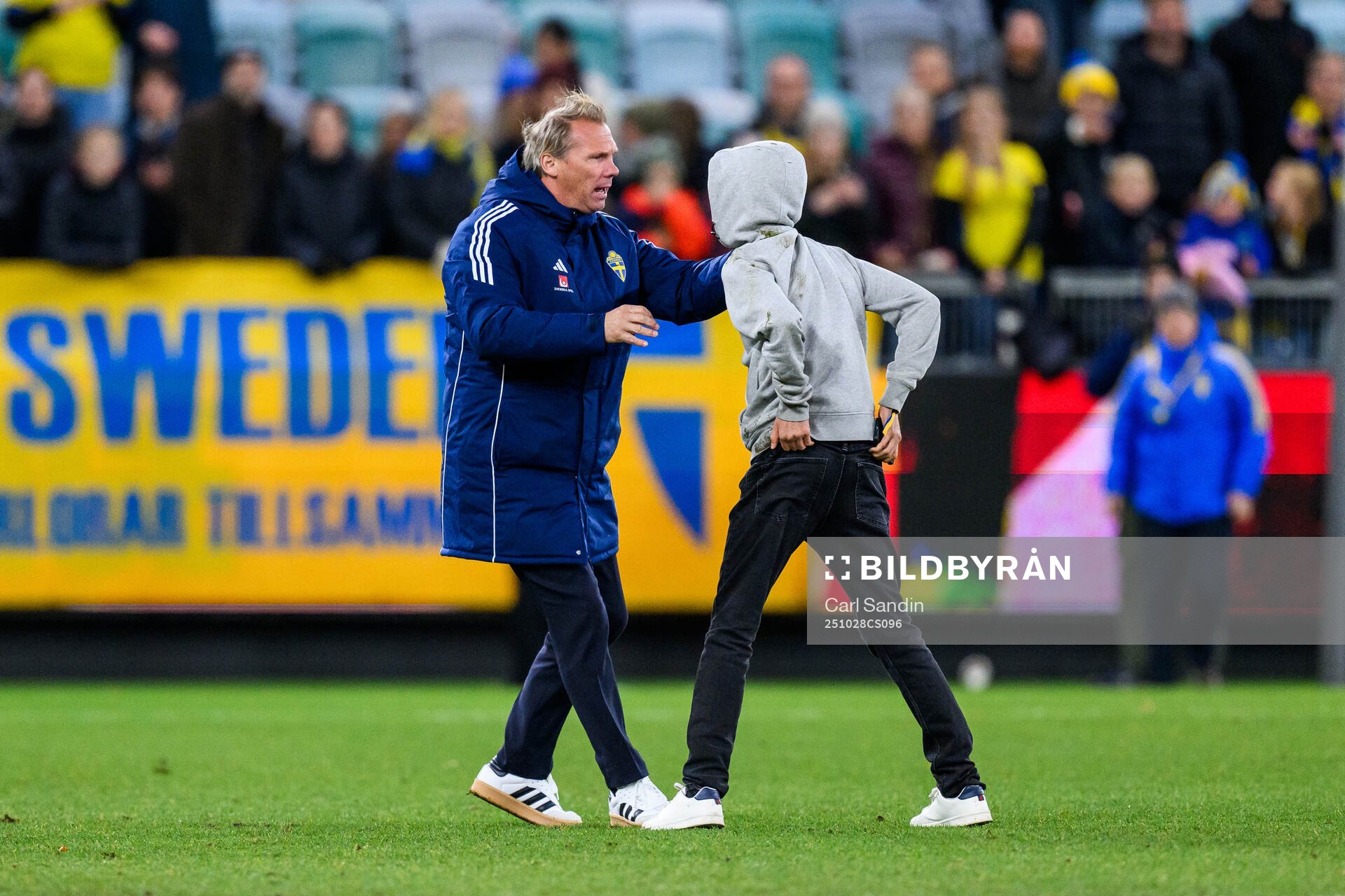 Security manager Lars From stops a pitch invader