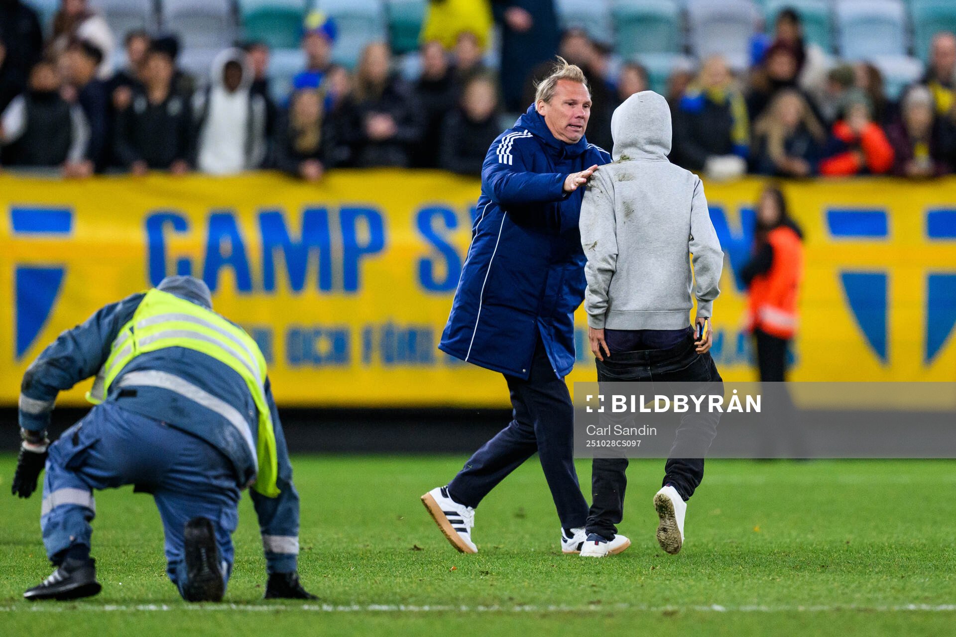 Security manager Lars From stops a pitch invader