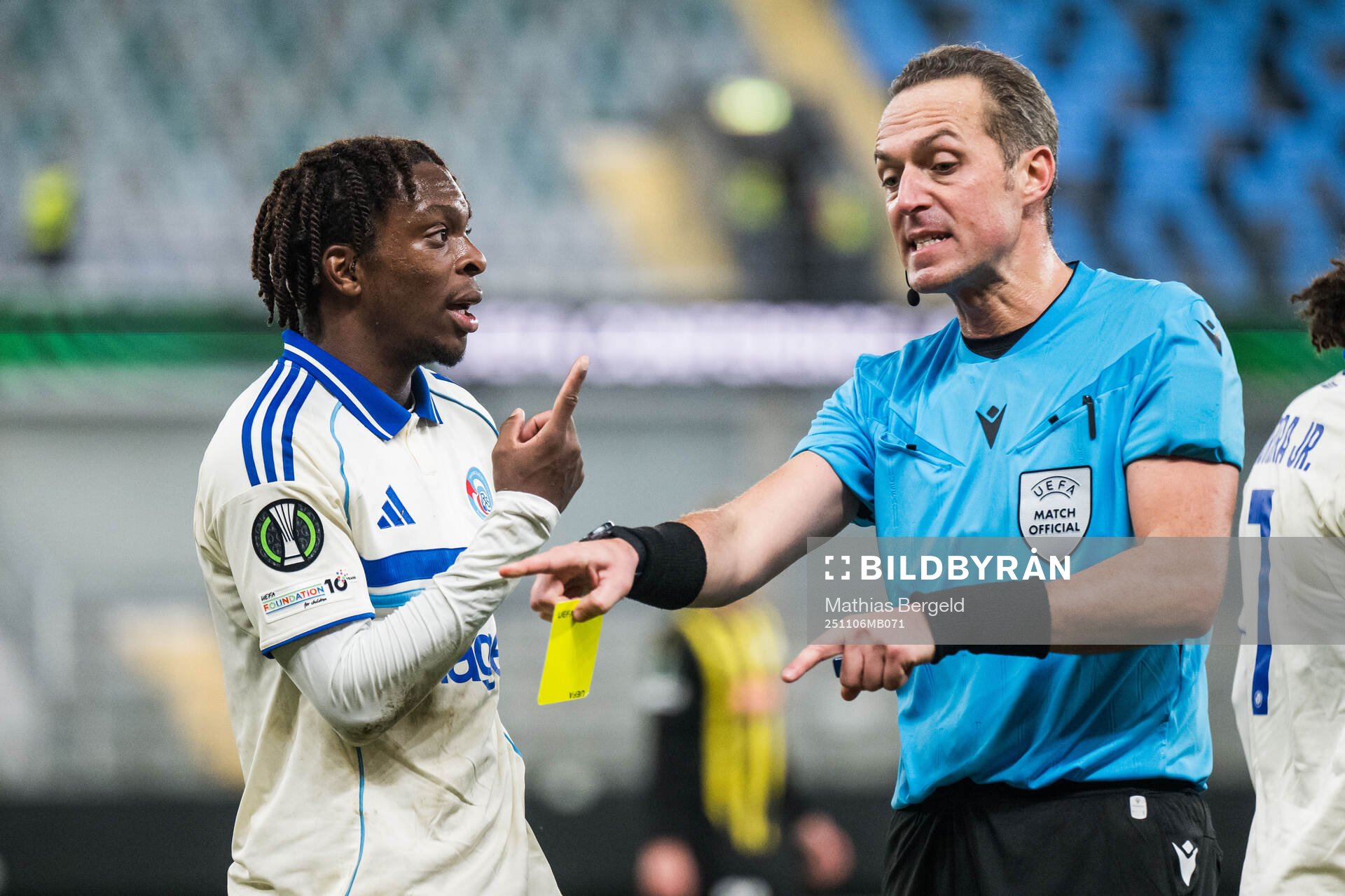 Martial Godo of Strasbourg receives a yellow card från