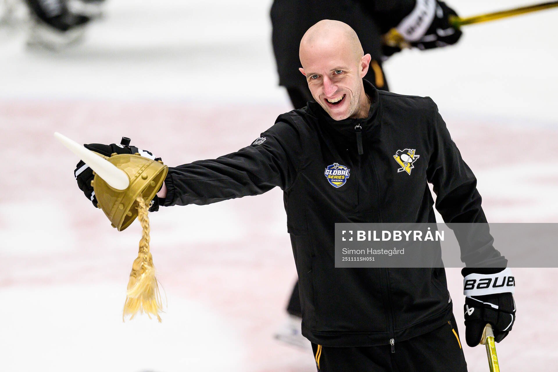 Head coach Dan Muse with a toy viking helmet