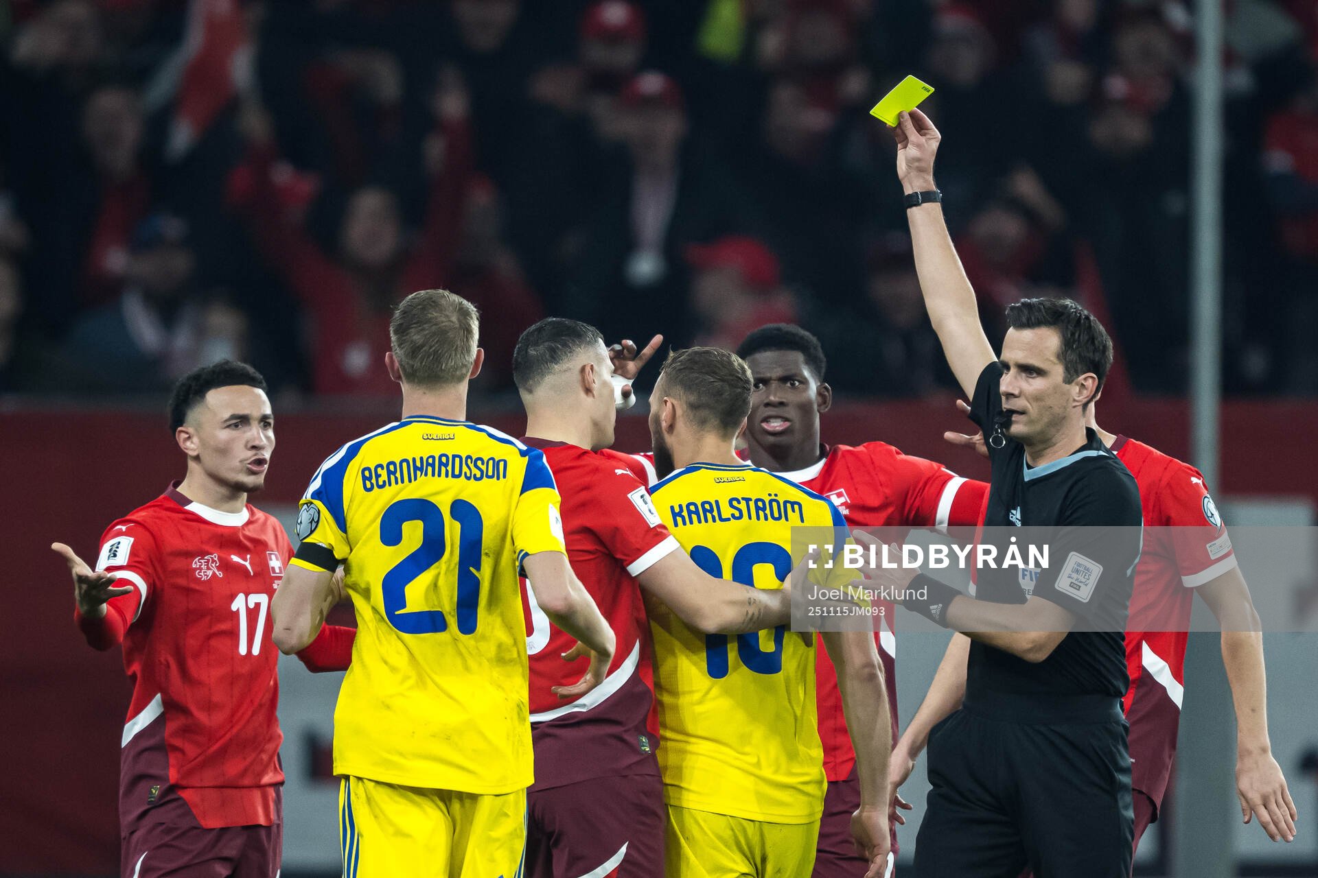 Jesper Karlström of Sweden receives a yellow card