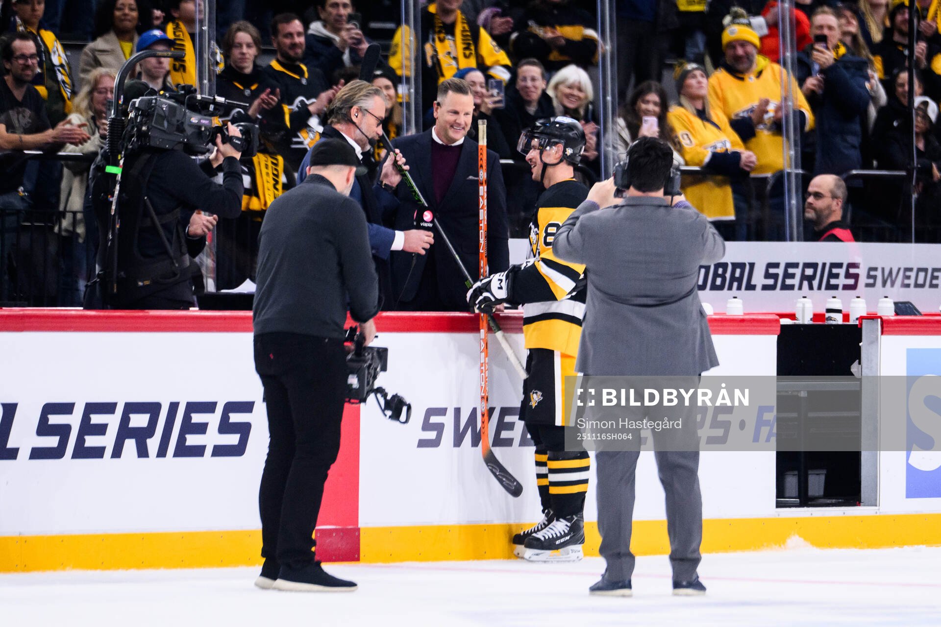 Sidney Crosby of Pittsburgh Penguins receives a hockey