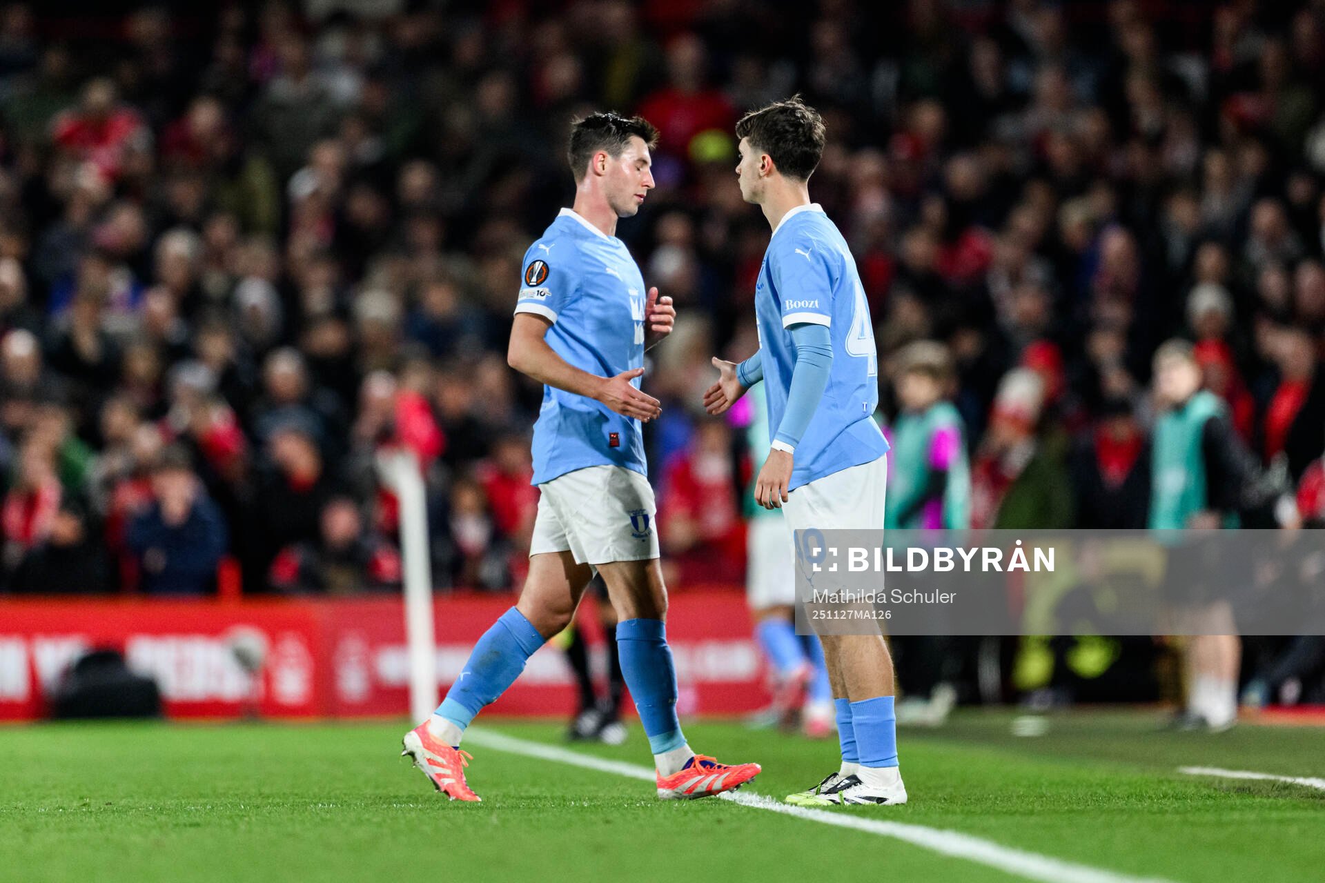 Lasse Berg Johnsen changes with Kenan Busuladzic of Malmö