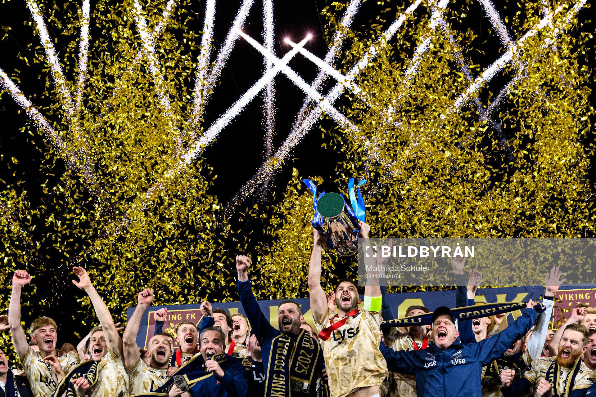 Zlatko Tripic of Viking lifts the trophy together with head