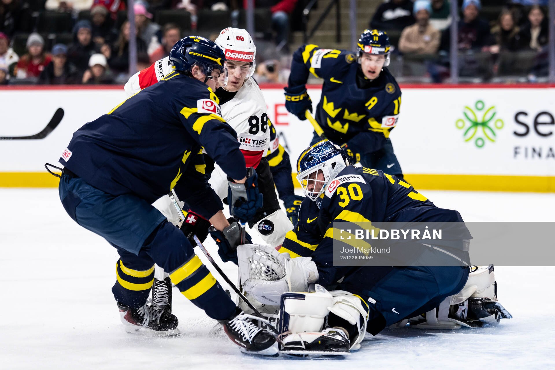 Felix Carell and goaltender Love Härenstam of Sweden
