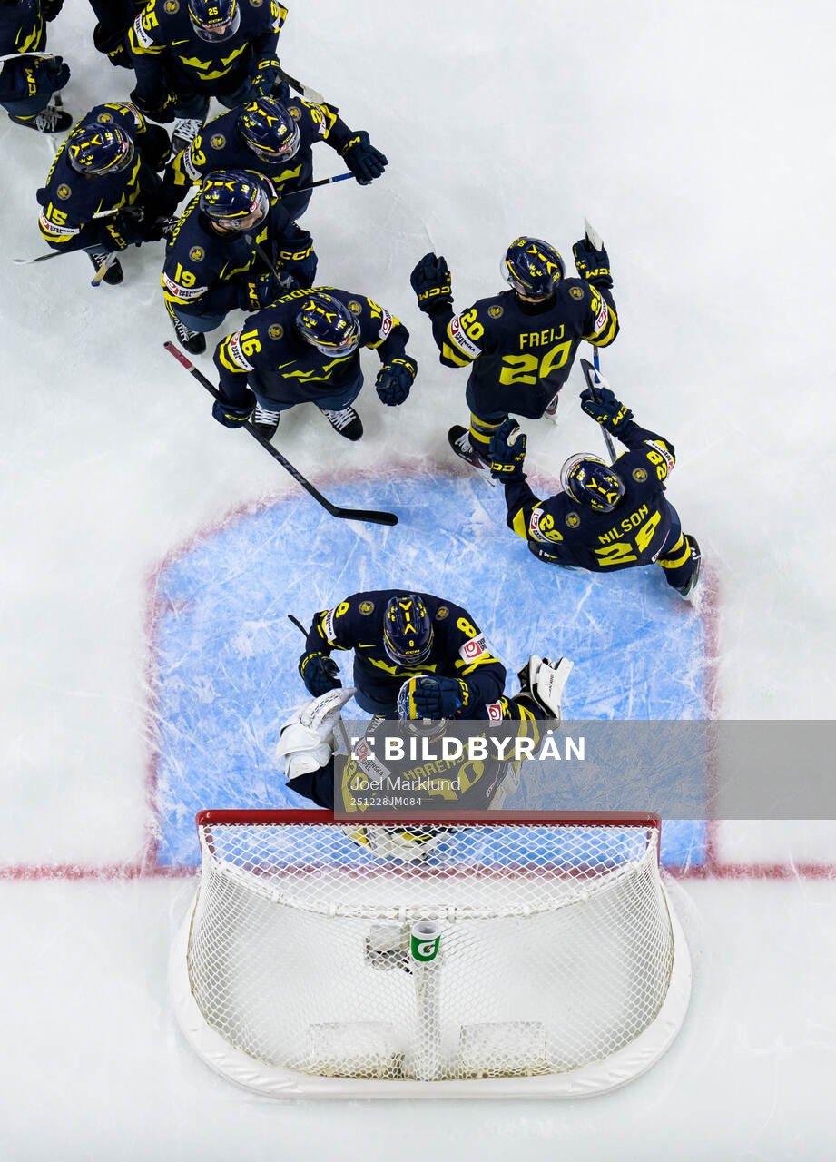 Players of Sweden celebrate together with goaltender Love