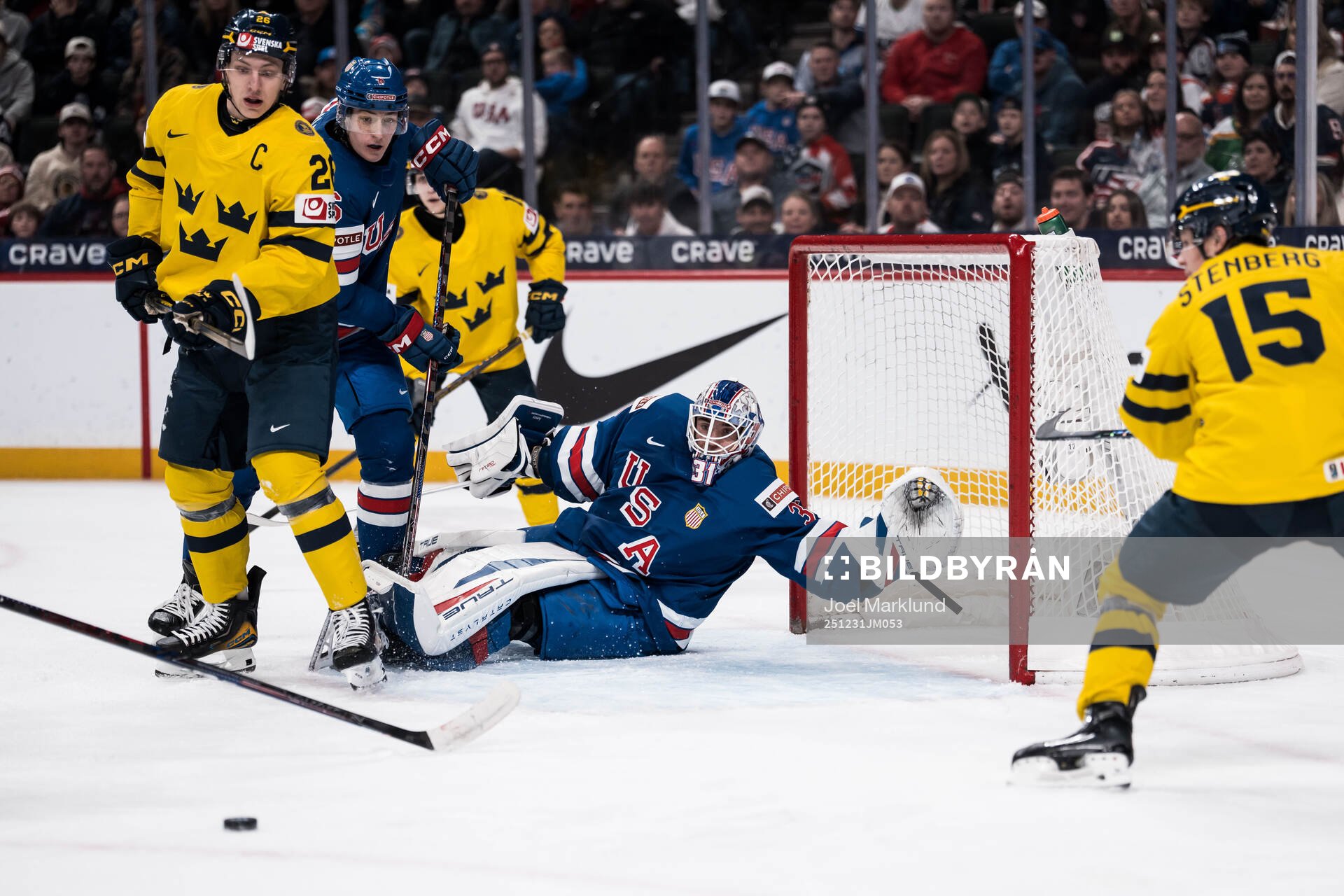 Jack Berglund of Sweden and goaltender Nicholas Kempf of