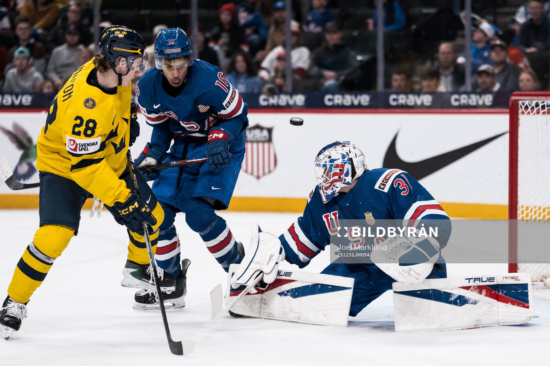 Eric Nilson of Sweden and E.J. Emery and goaltender
