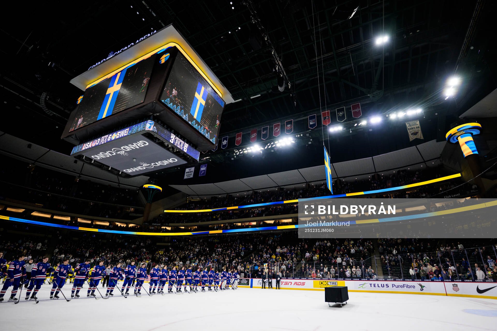 Players of Sweden and USA listen to the Swedish national