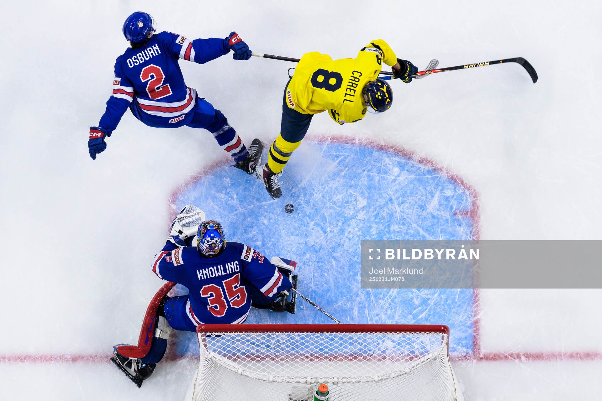 Luke Osburn and goaltender Brady Knowling of USA are being