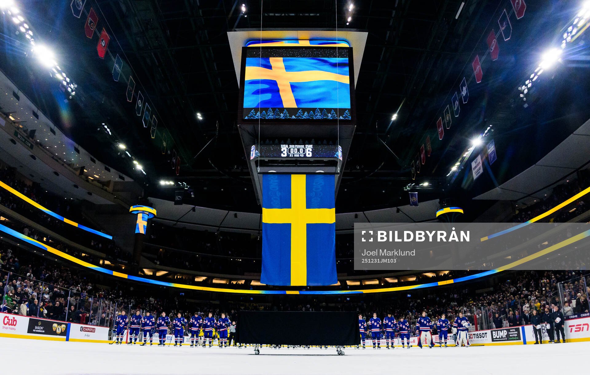 Players of Sweden and USA listen to the Swedish national