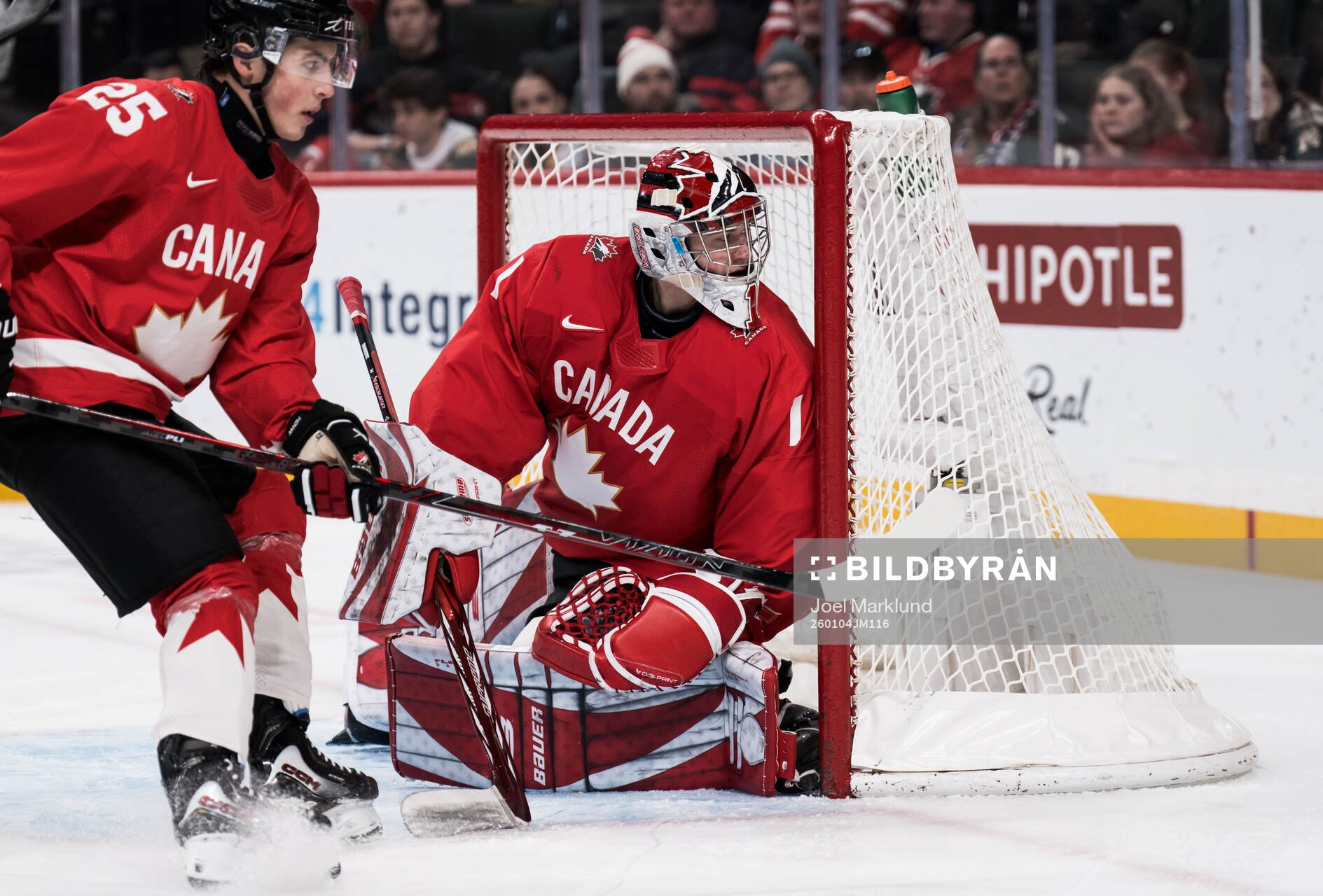 Caleb Desnoyers and goaltender Jack Ivankovic of Canada