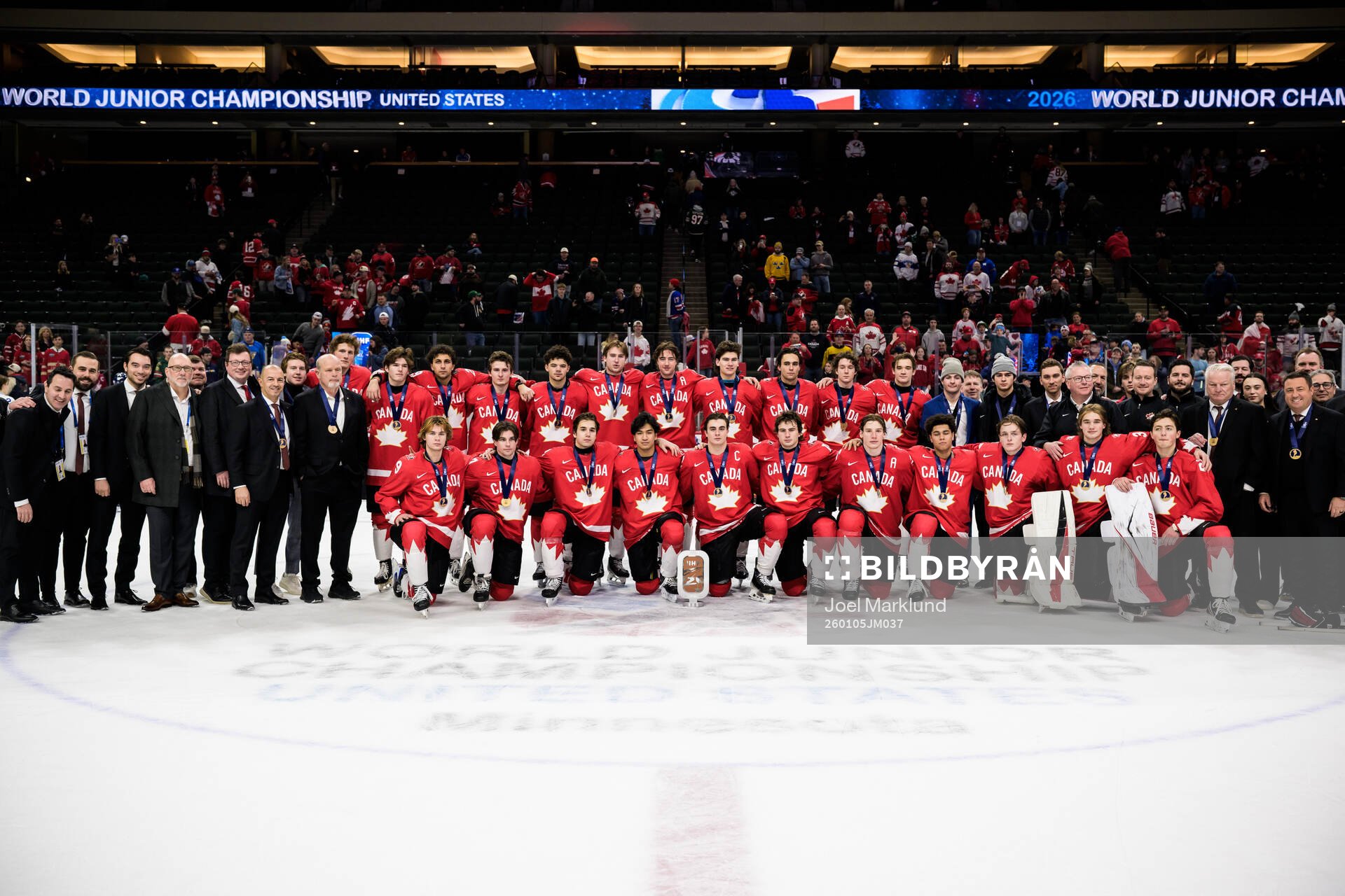 Players and coaching staff of Canada pose with the bronze
