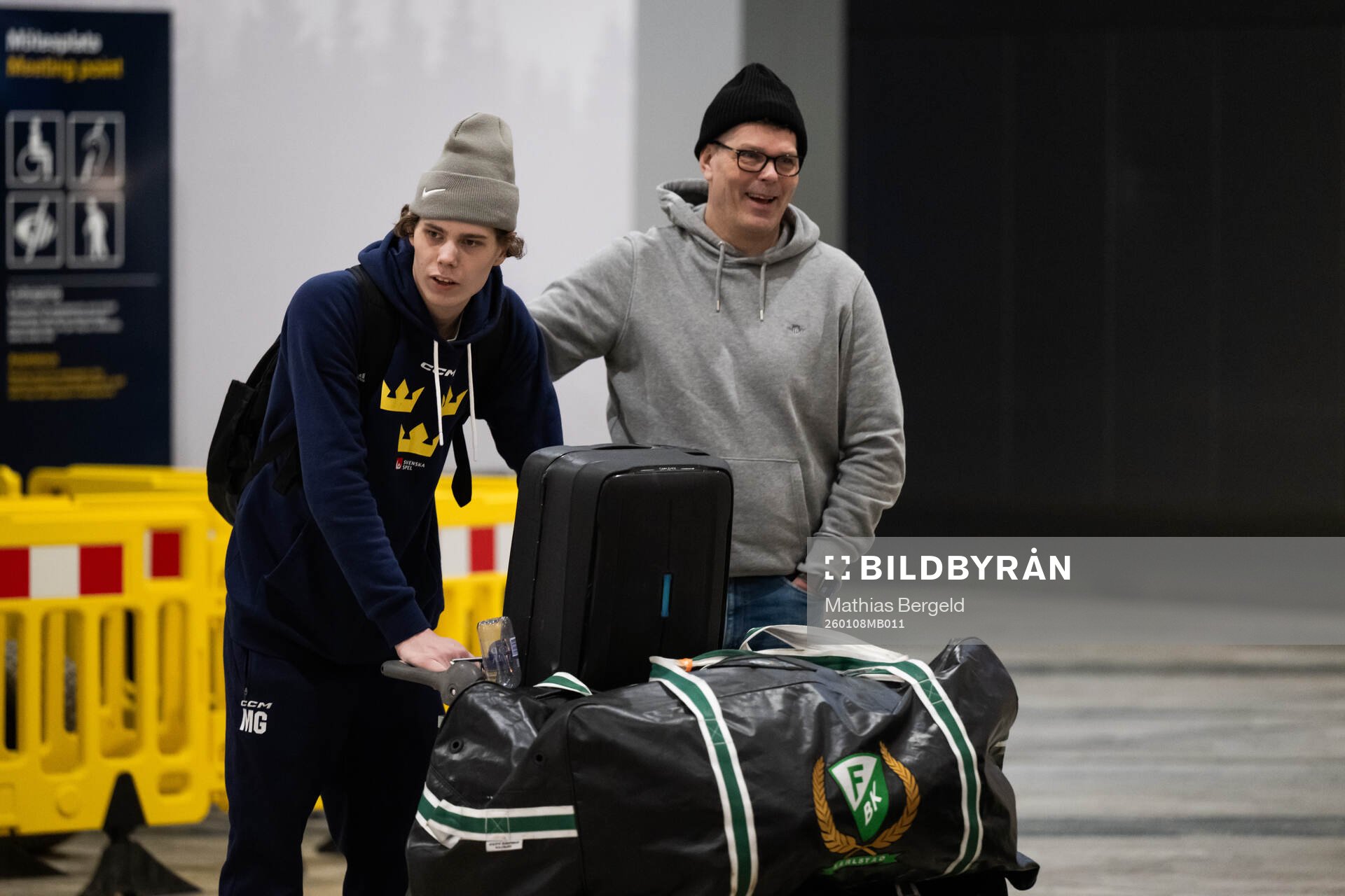 Måns Goos is met by his father Peter Goos as he arrives at