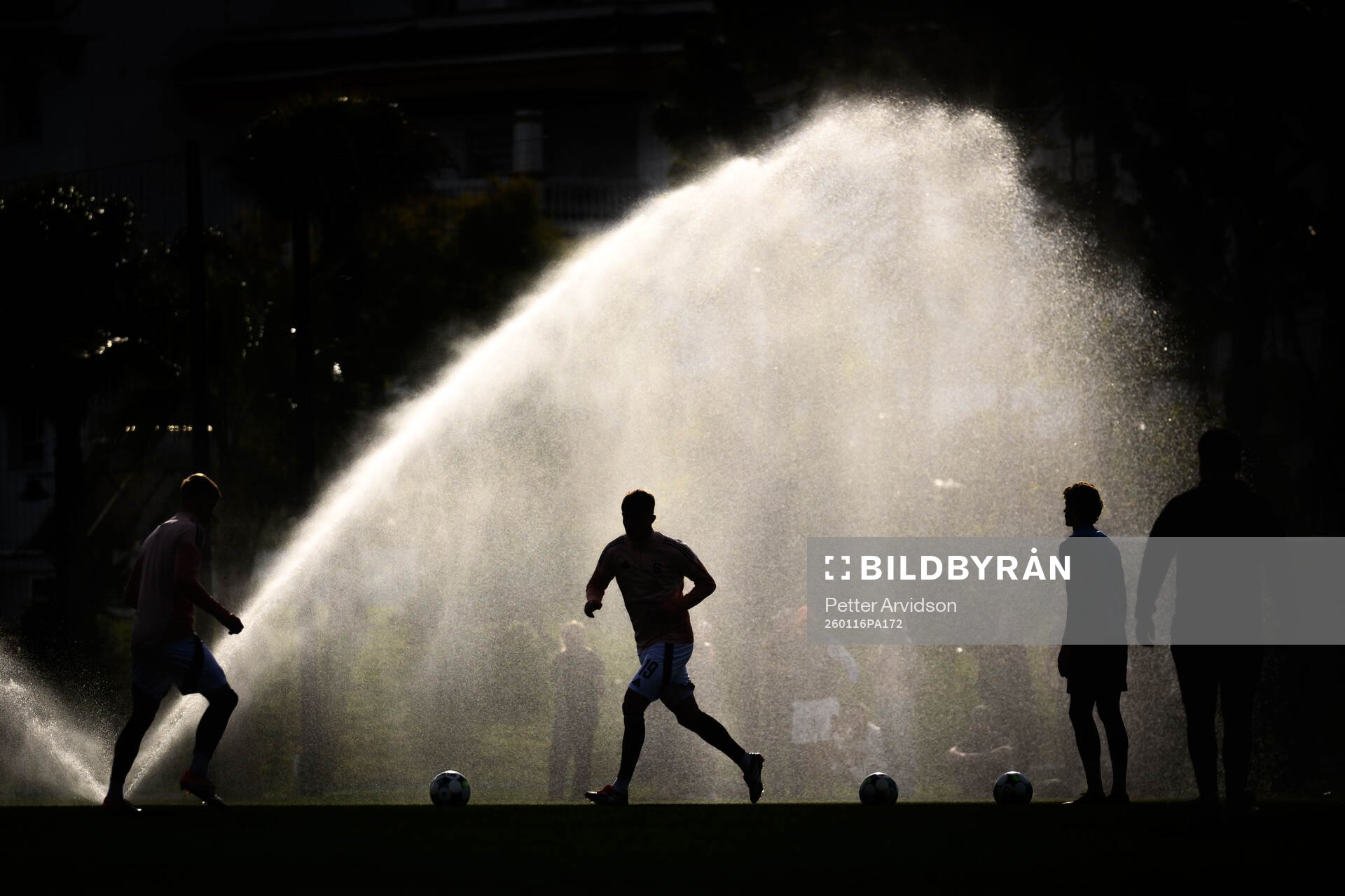 General view of a player infront of a sprinkler