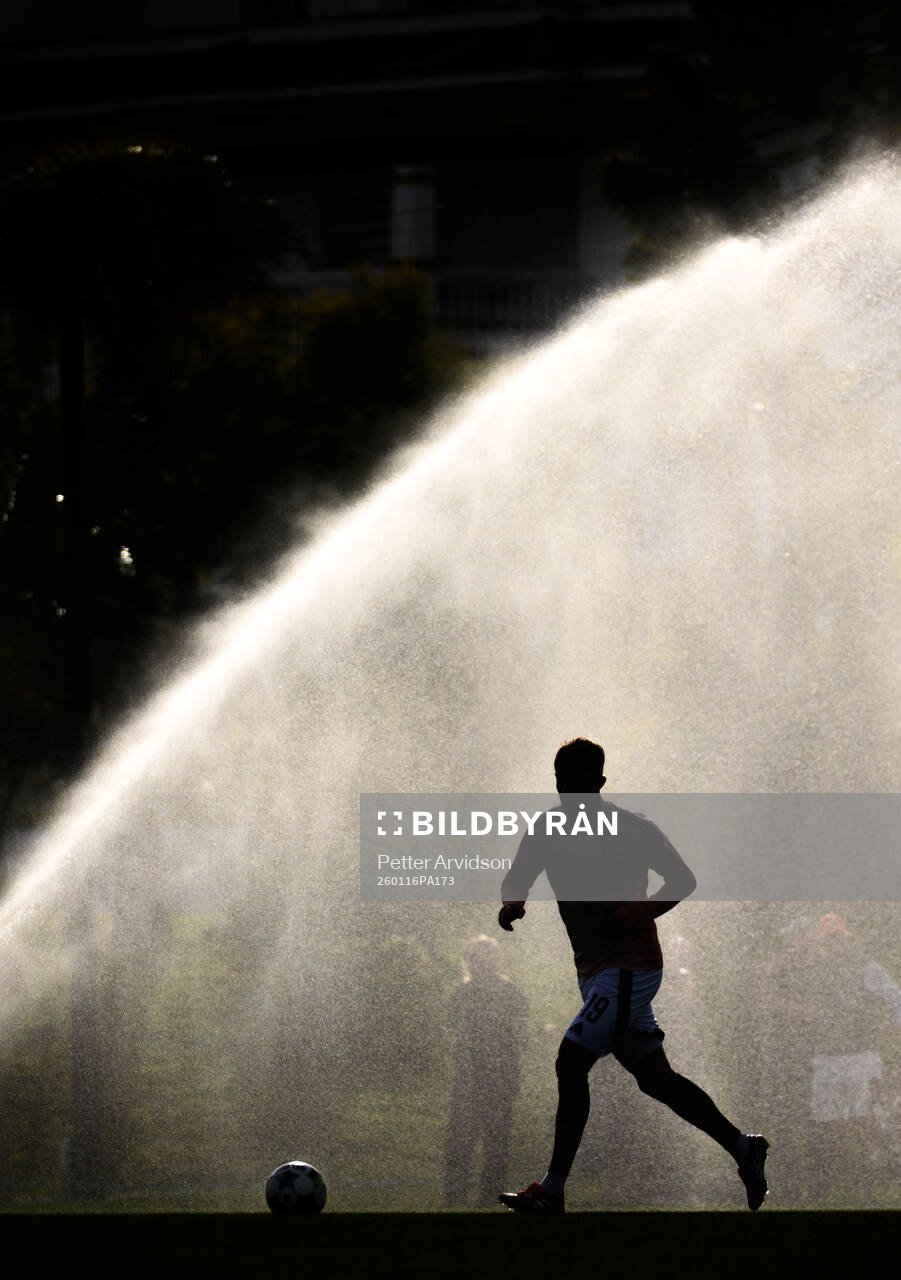 General view of a player infront of a sprinkler