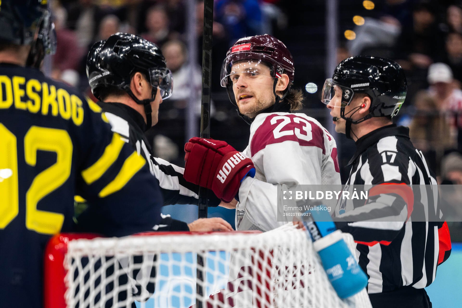 Teodors Blugers of Latvia reacts in the men's ice hockey