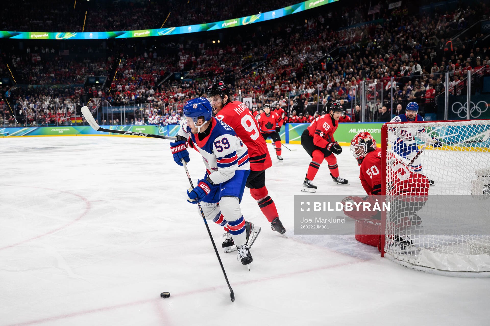Jake Guentzel of USA against Connor McDavid and goaltender