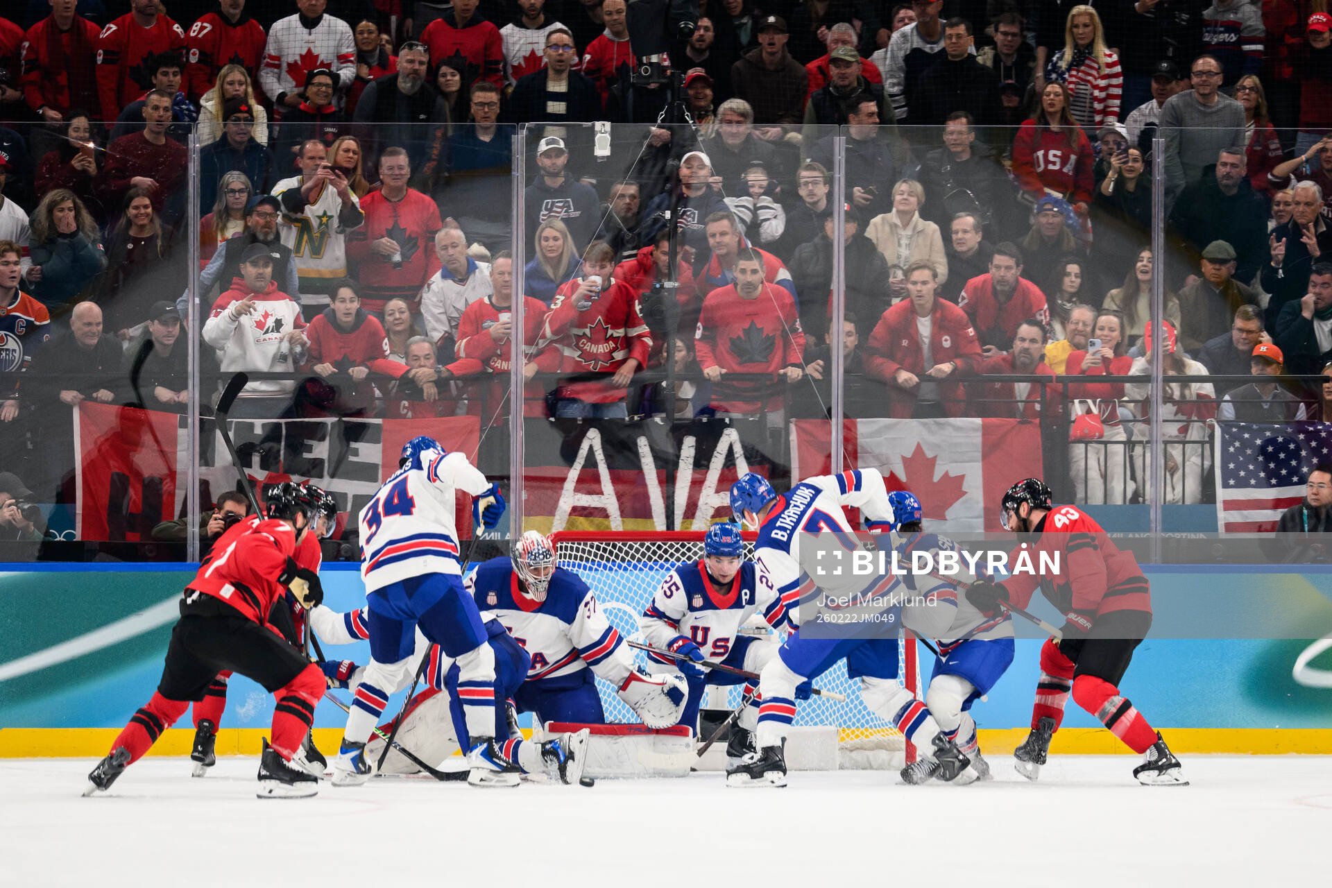 Tom Wilson of Canada against goaltender Connor Hellebuyck