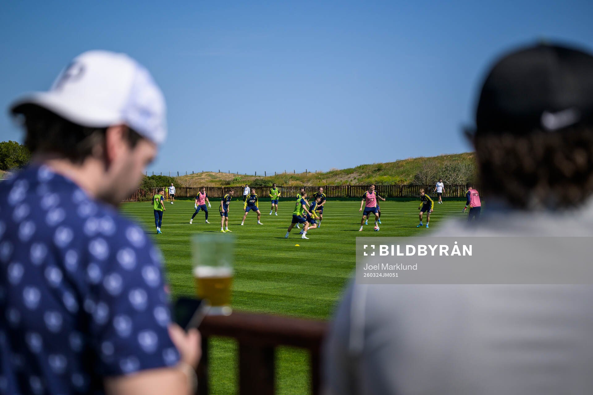 Spectators with beers watching players of the Swedish