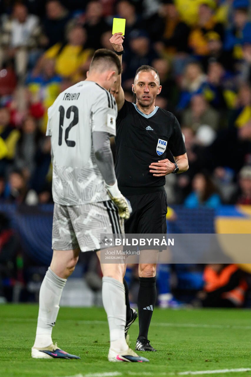 goalkeeper Anatoliy Trubin of Ukraine is shown a yellow