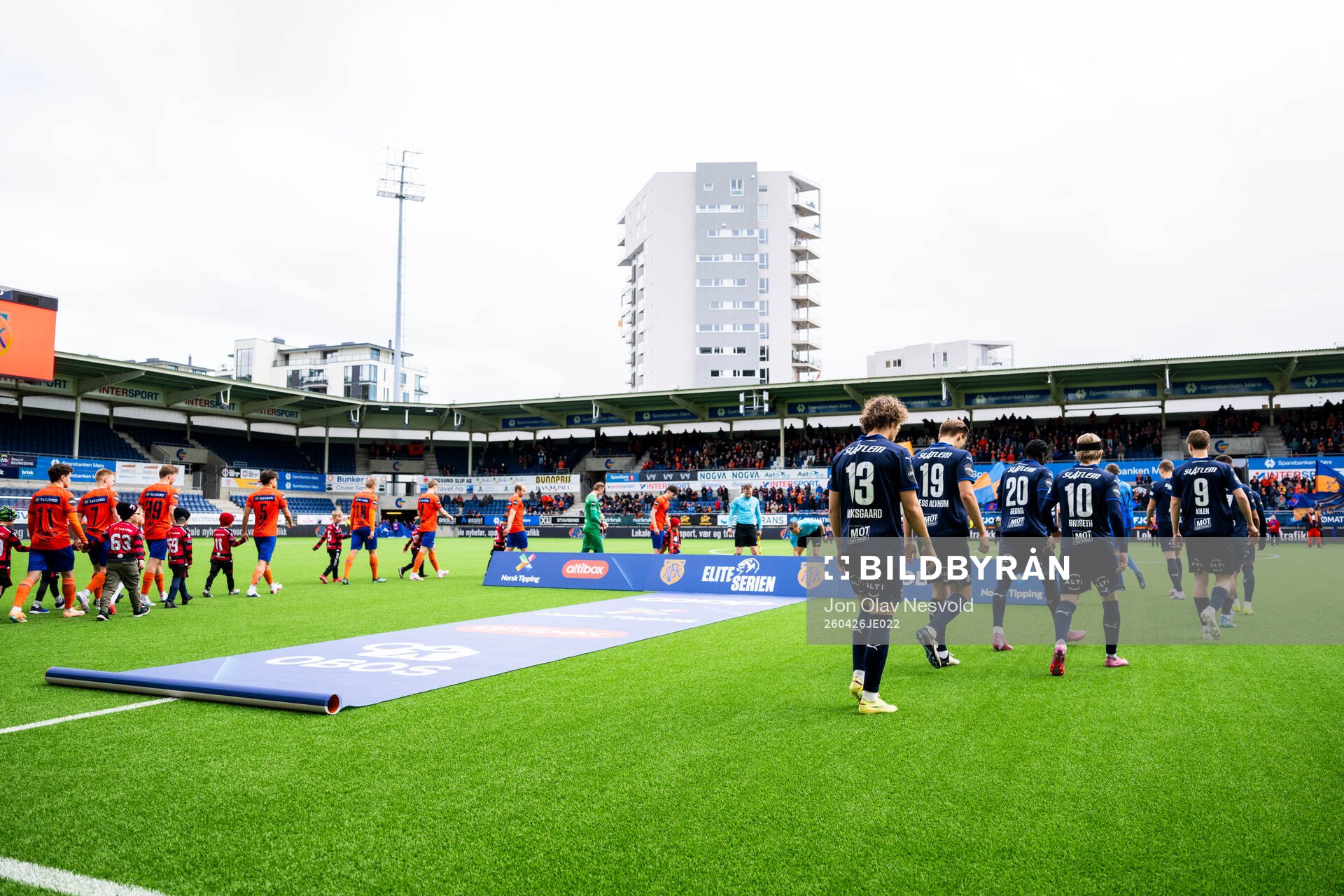The teams enter the pitch