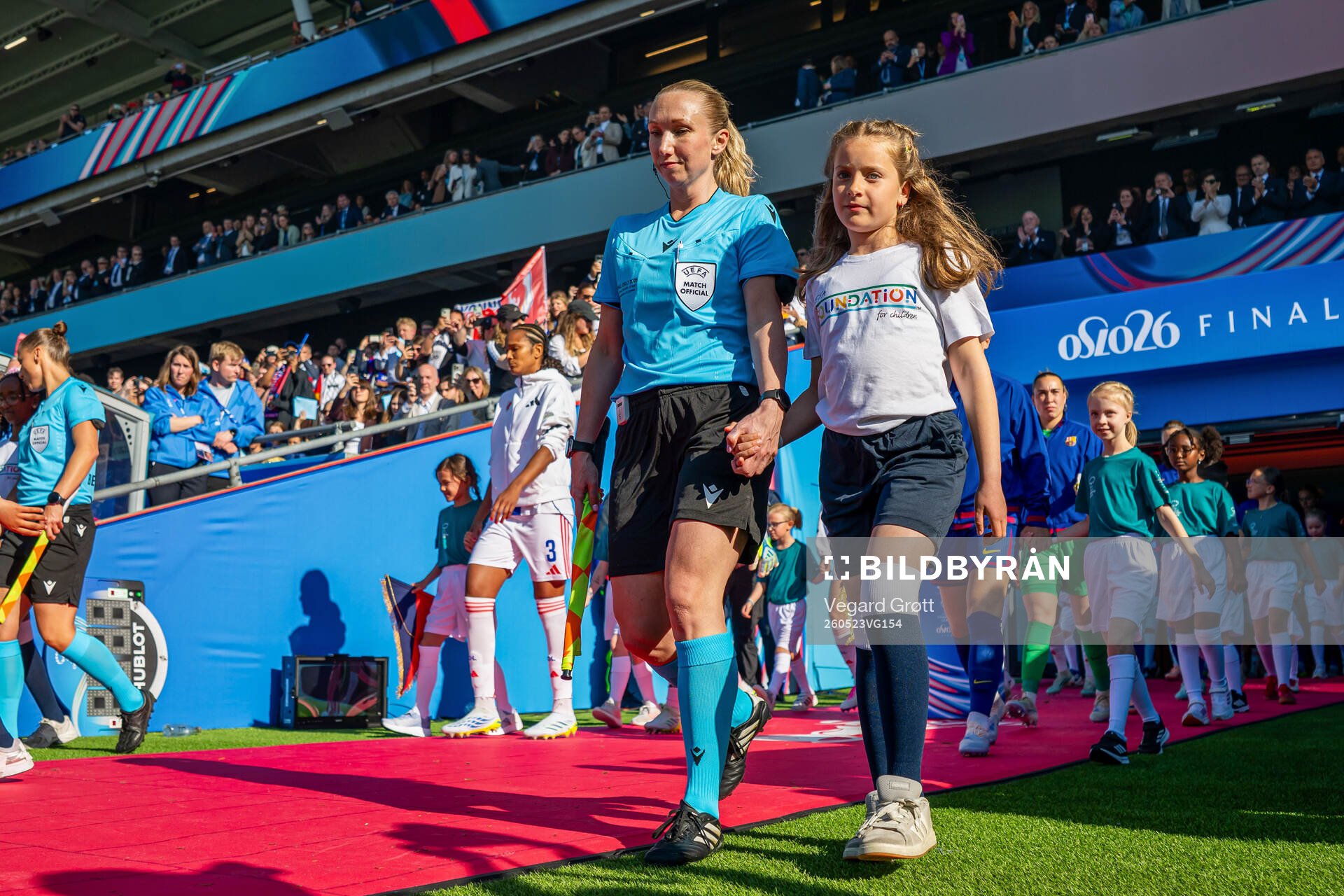 Assistant referee Monica Løkkeberg enters the pitch