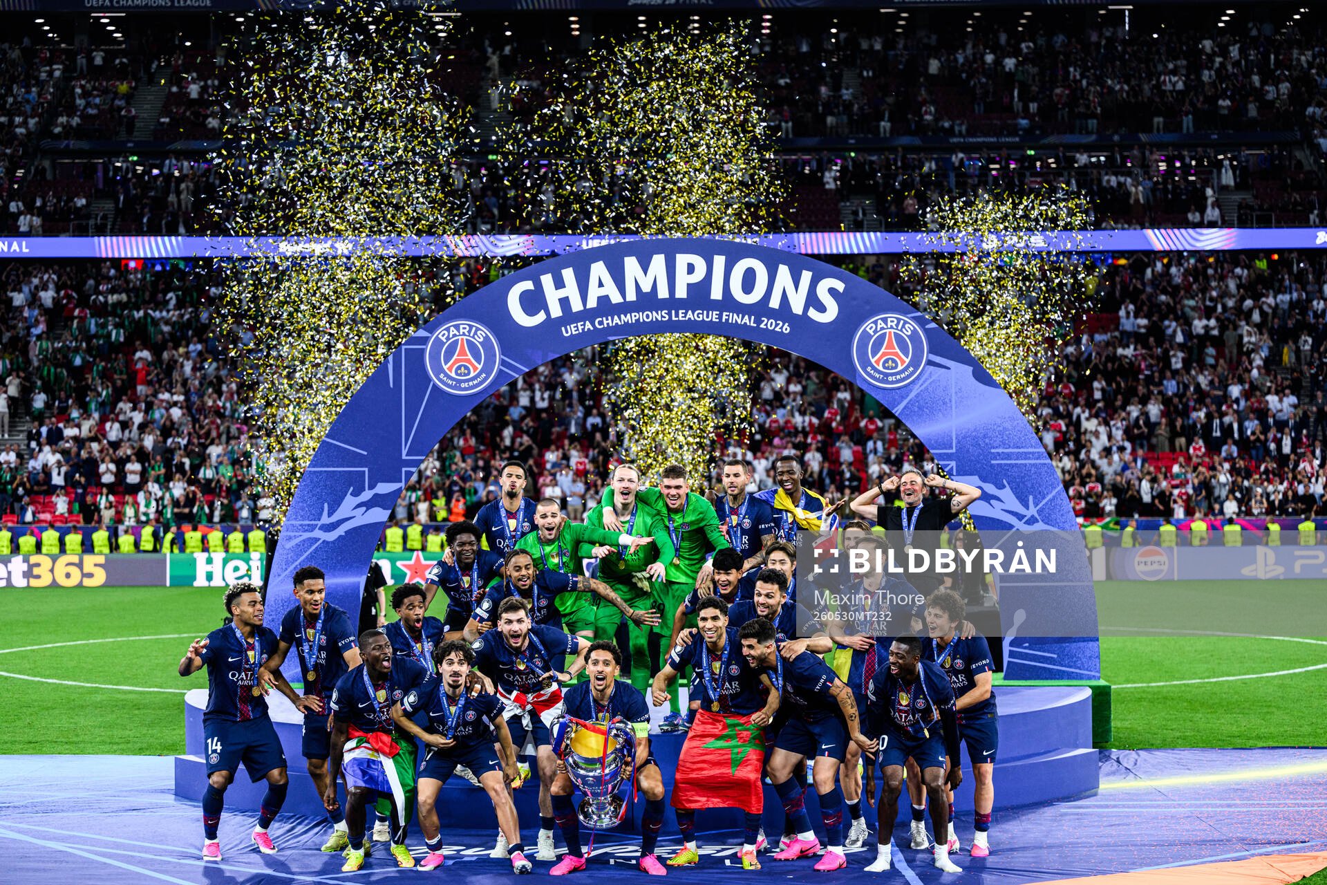 Players of Paris Saint-Germain celebrate with the trophy