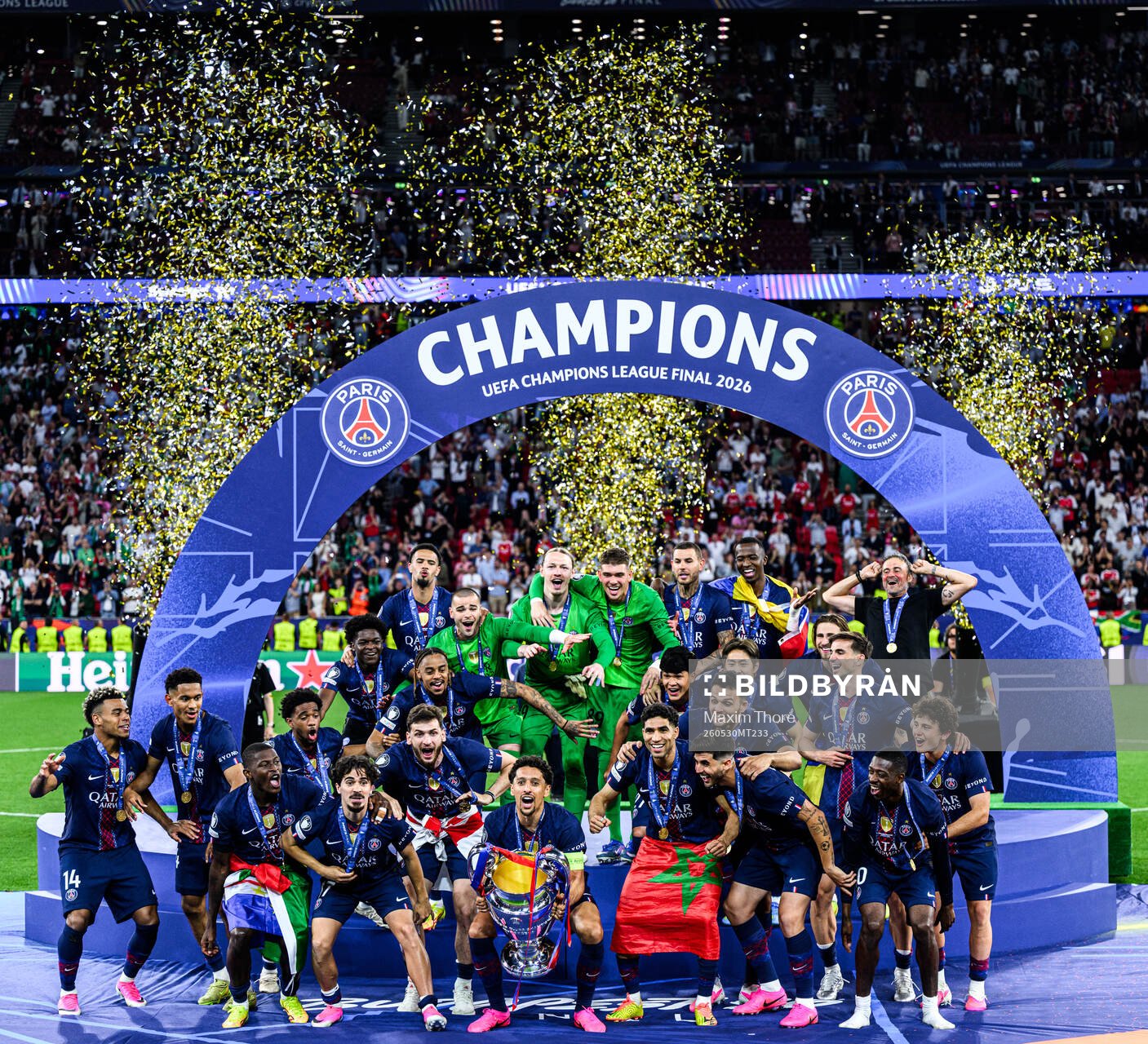 Players of Paris Saint-Germain celebrate with the trophy