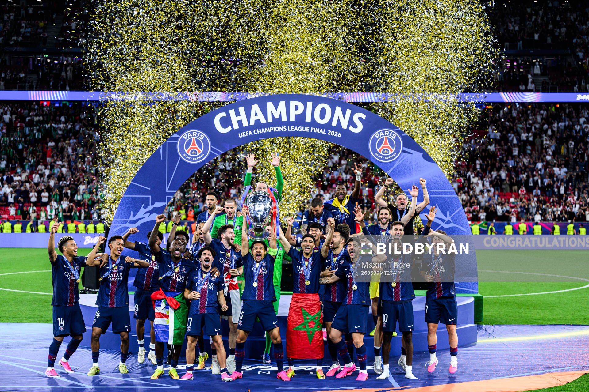 Players of Paris Saint-Germain celebrate with the trophy