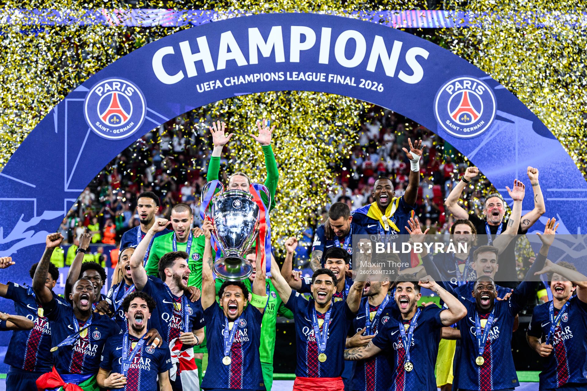 Players of Paris Saint-Germain celebrate with the trophy