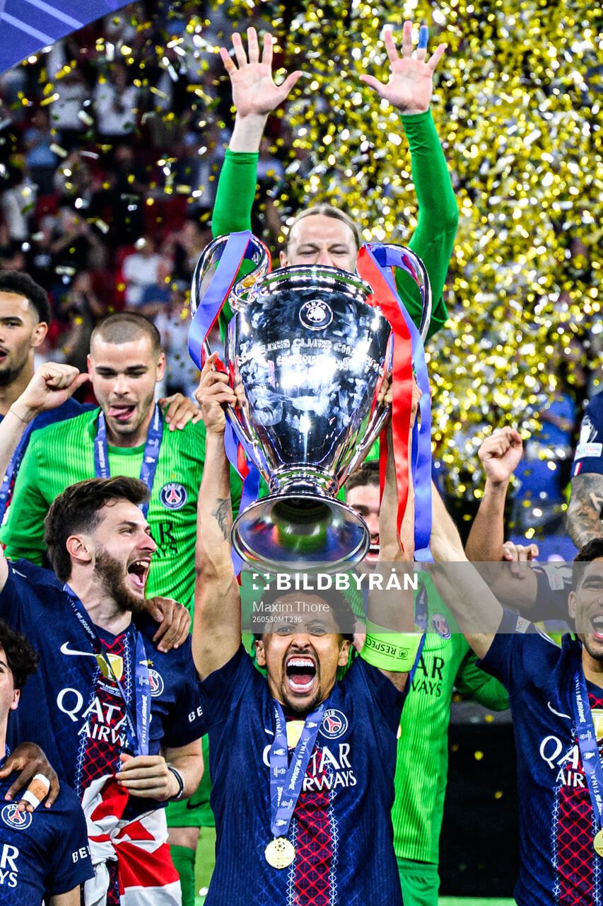 Players of Paris Saint-Germain celebrate with the trophy